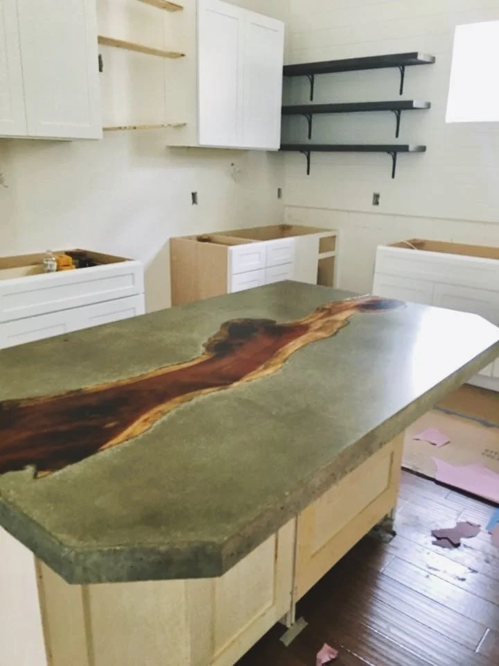 Custom concrete countertop with cedar inlay. Farmhouse style kitchen concrete counter.