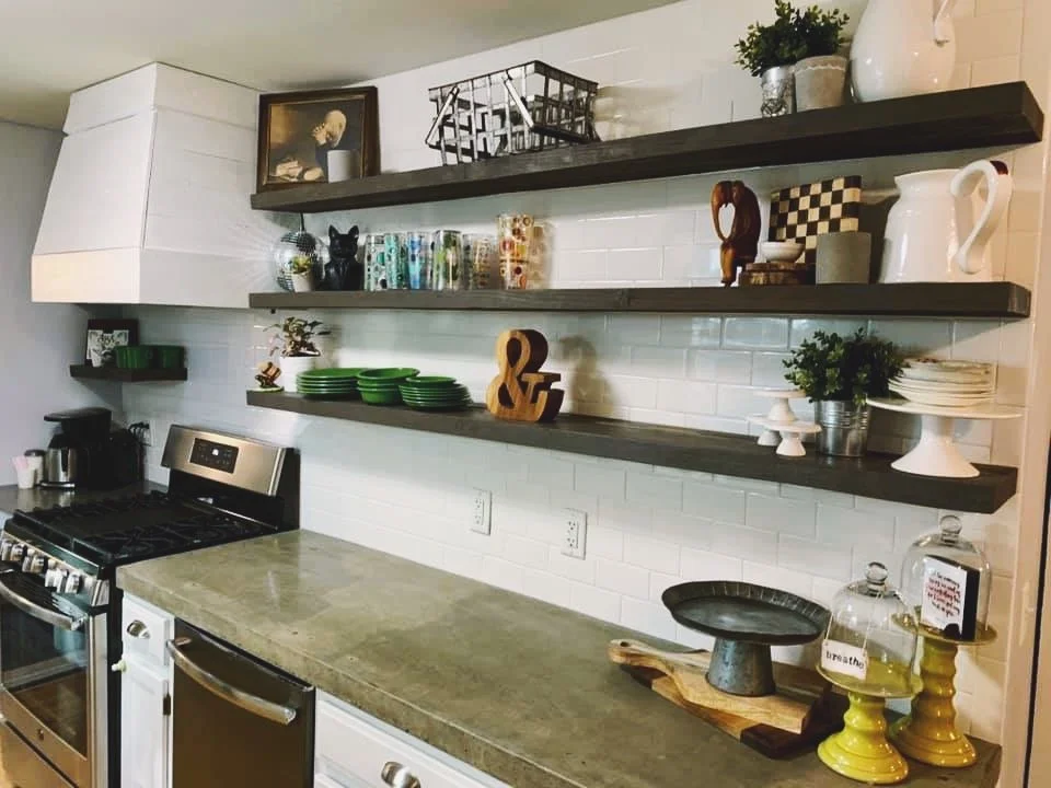 Custom concrete countertop kitchen renovation. Hood and cabinetry  and floating shelves also by Drake and sons. 