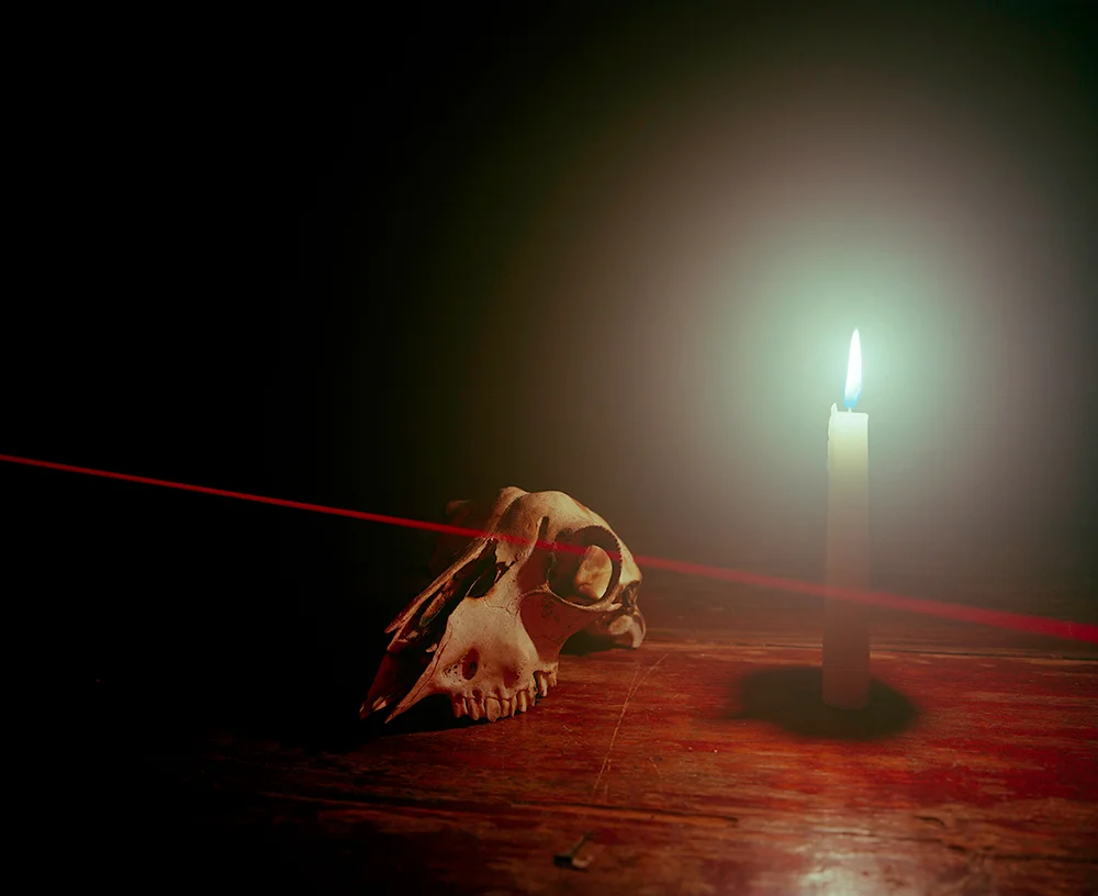 CANDLE, SKULL, AND LASER