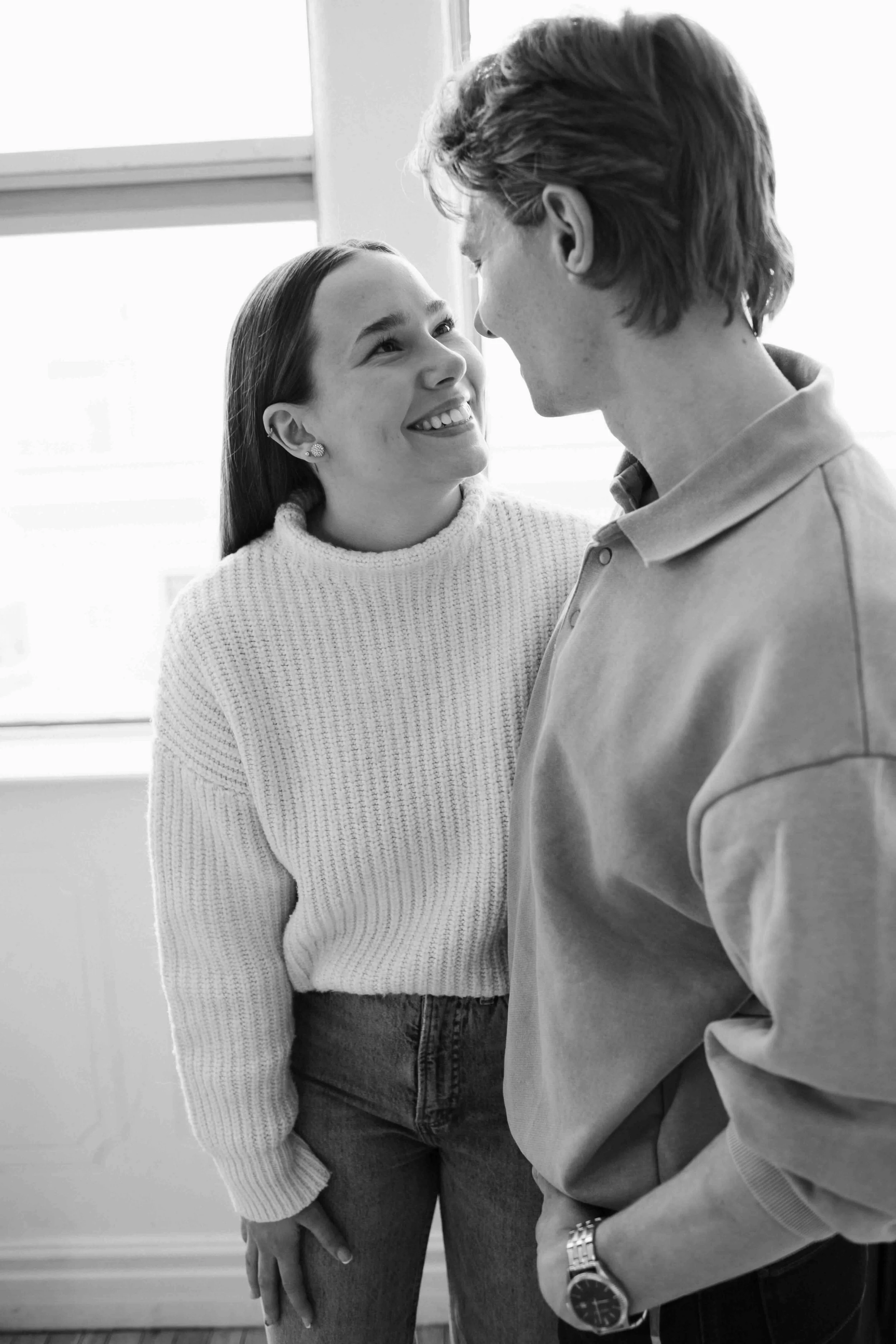 Playful Vancouver couple smiles at each other