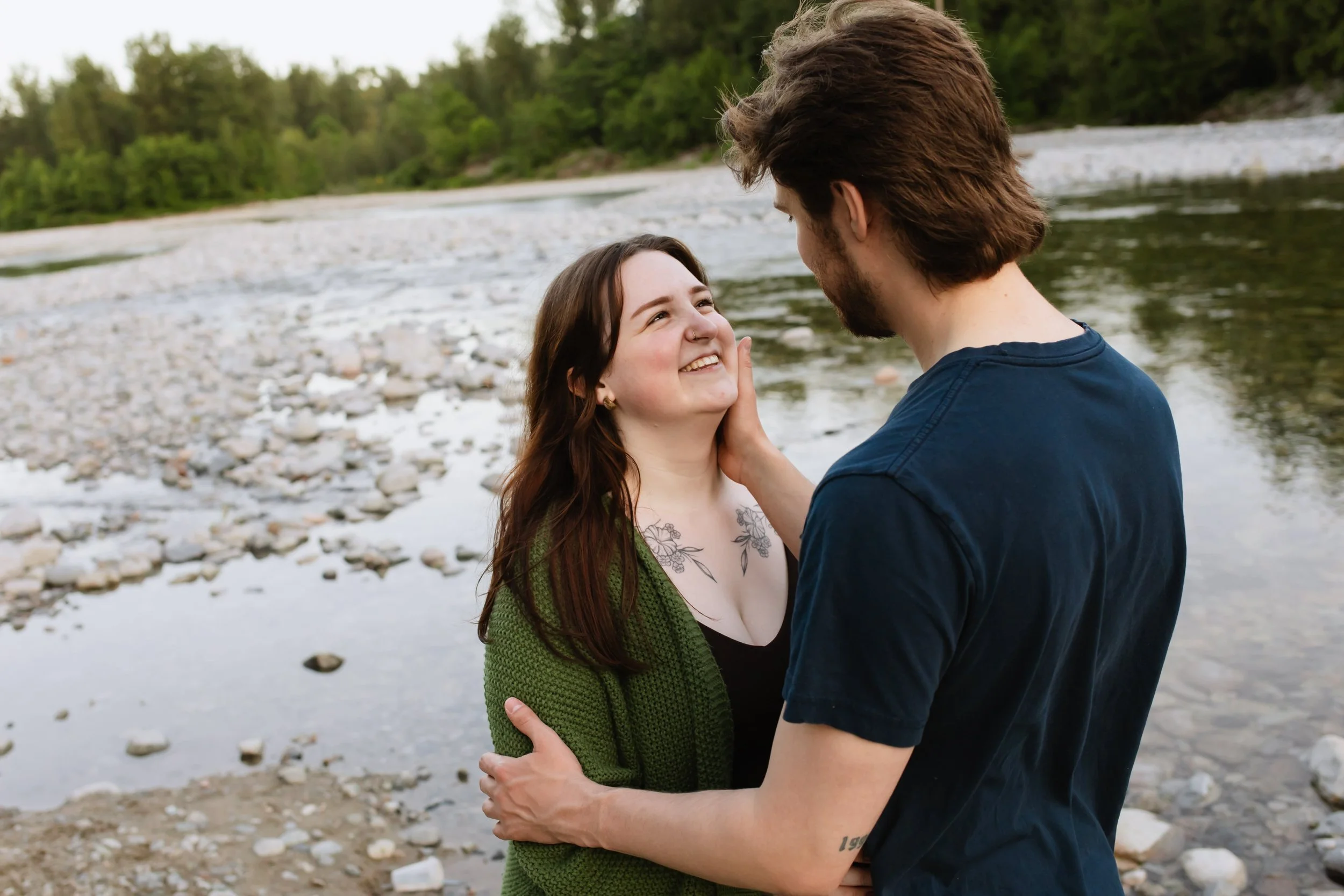 Vancouver man caresses girlfriend's face in the middle of a scenic rocky creek