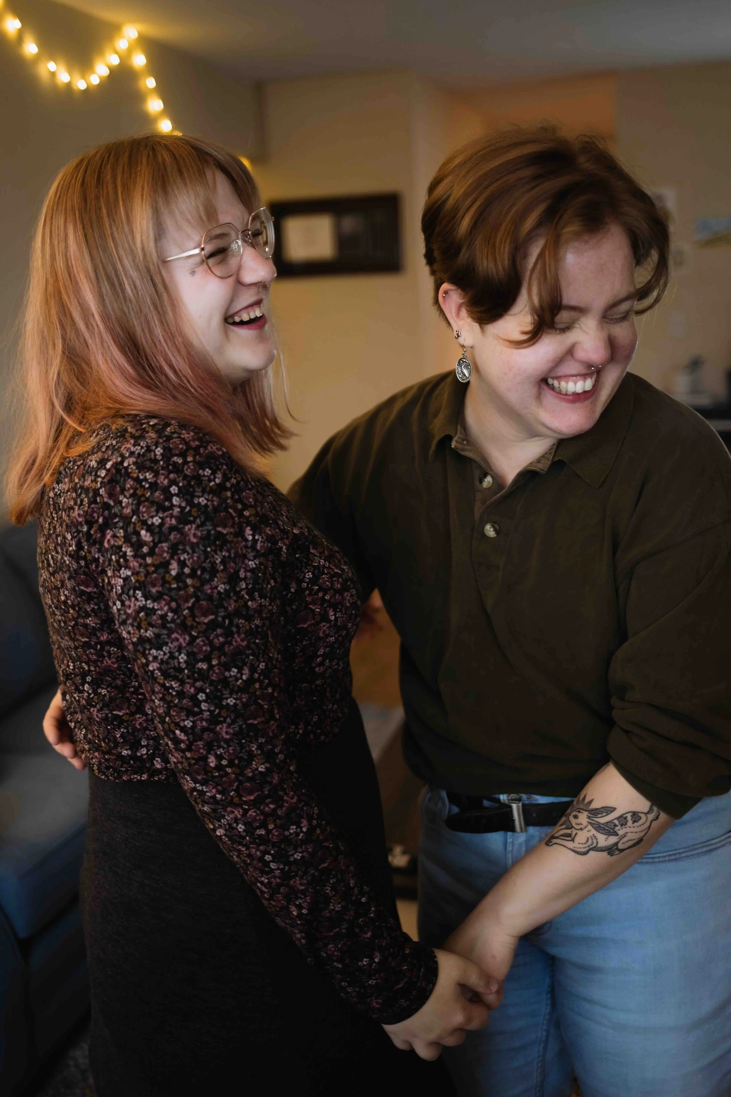 Queer Vancouver couple holds hands and laughs
