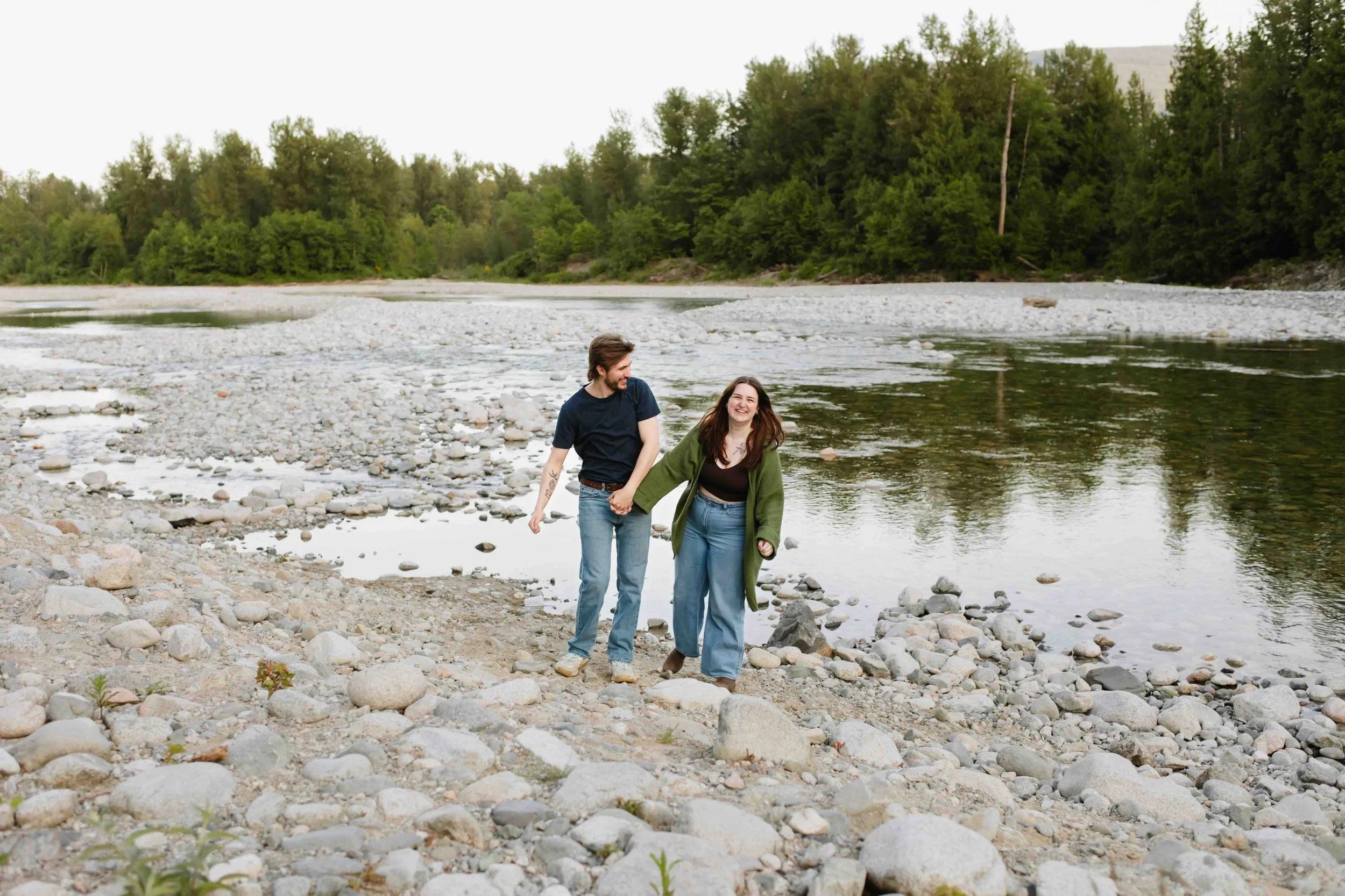 Vancouver couple holds hands and frolics through rocky riverbed