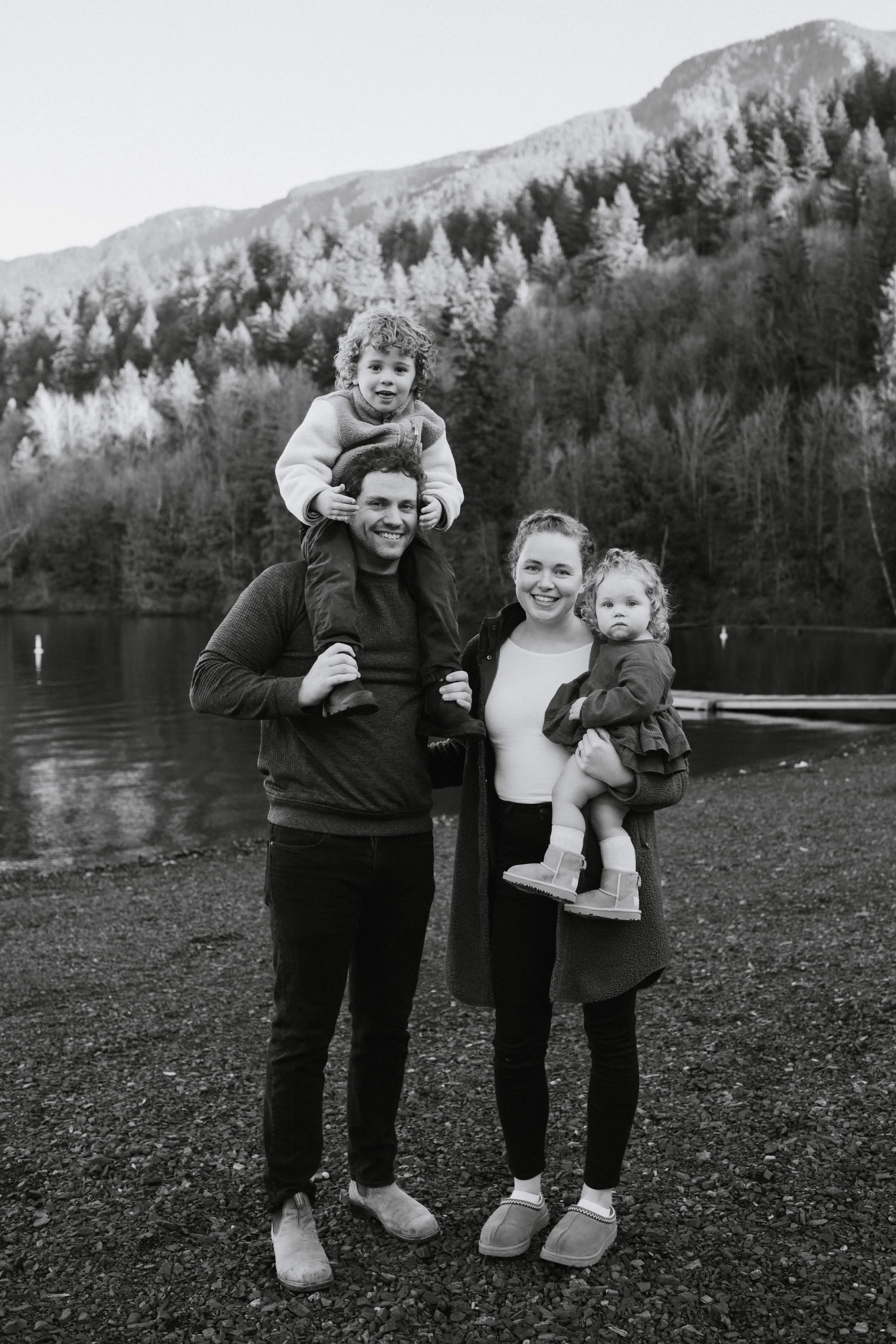 Young Vancouver family smiles holding piggyback kids at Cultus Lake