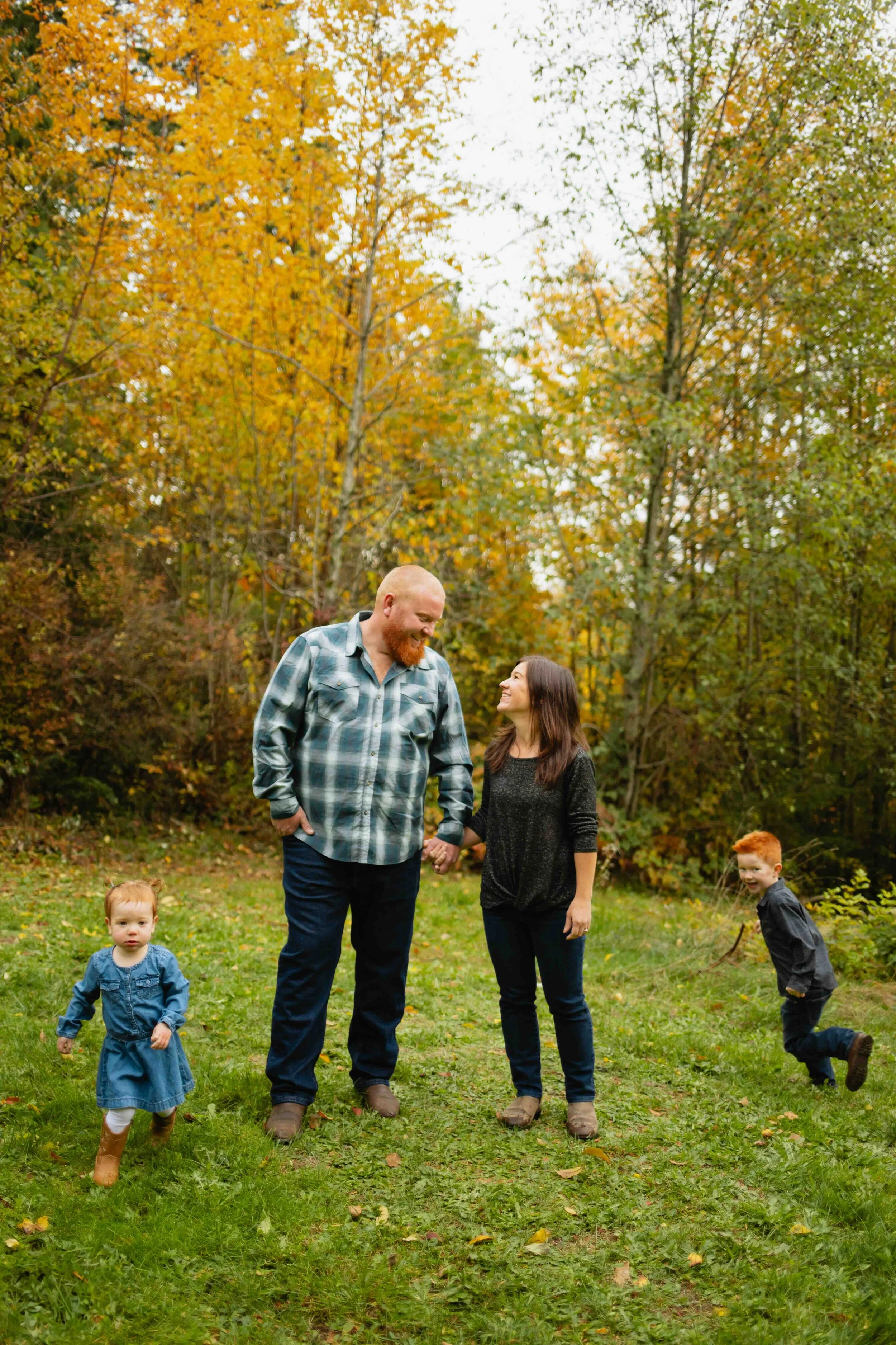 Young Vancouver family plays as kids run around their parents.