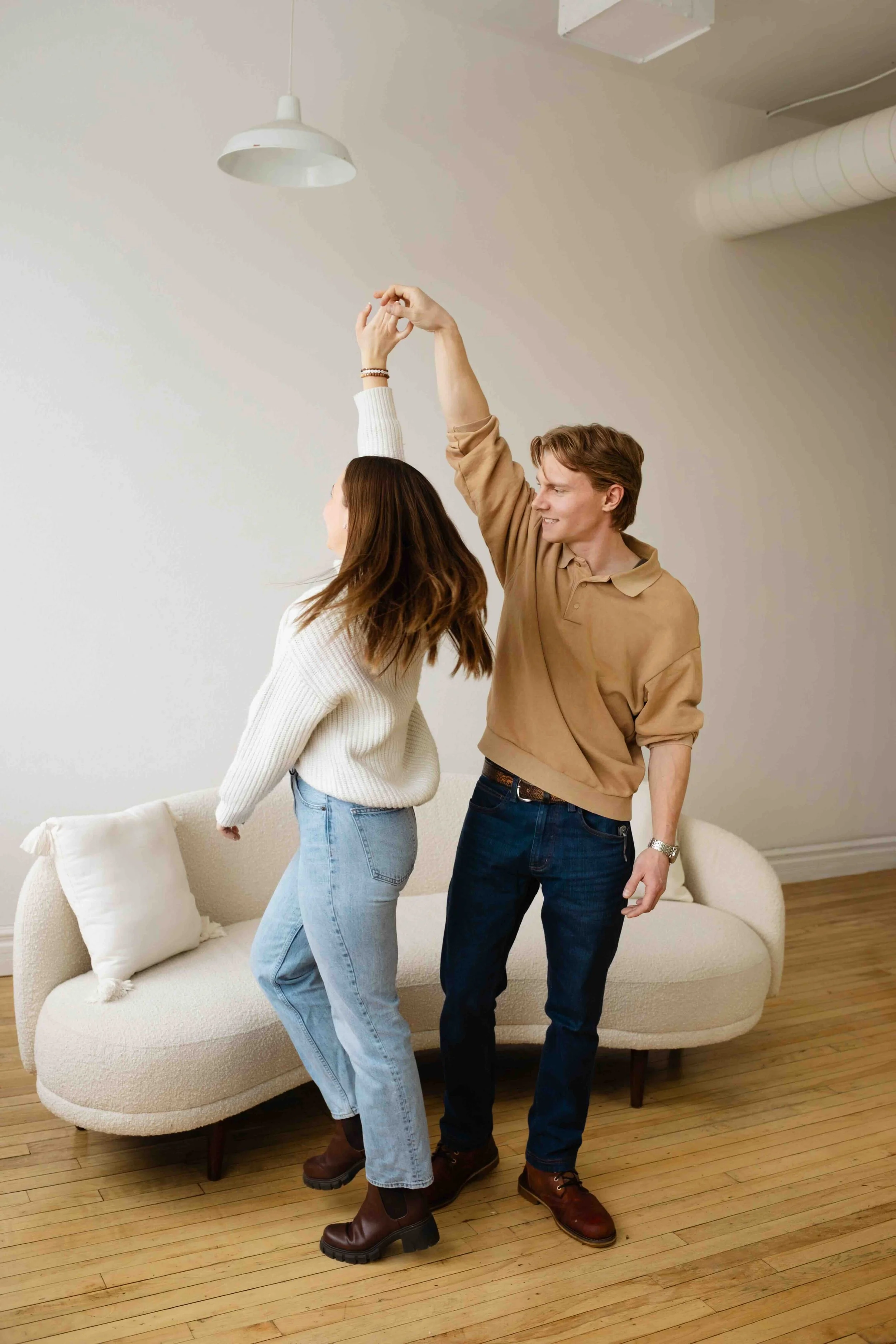 Playful Abbotsford couple twirling mid dance