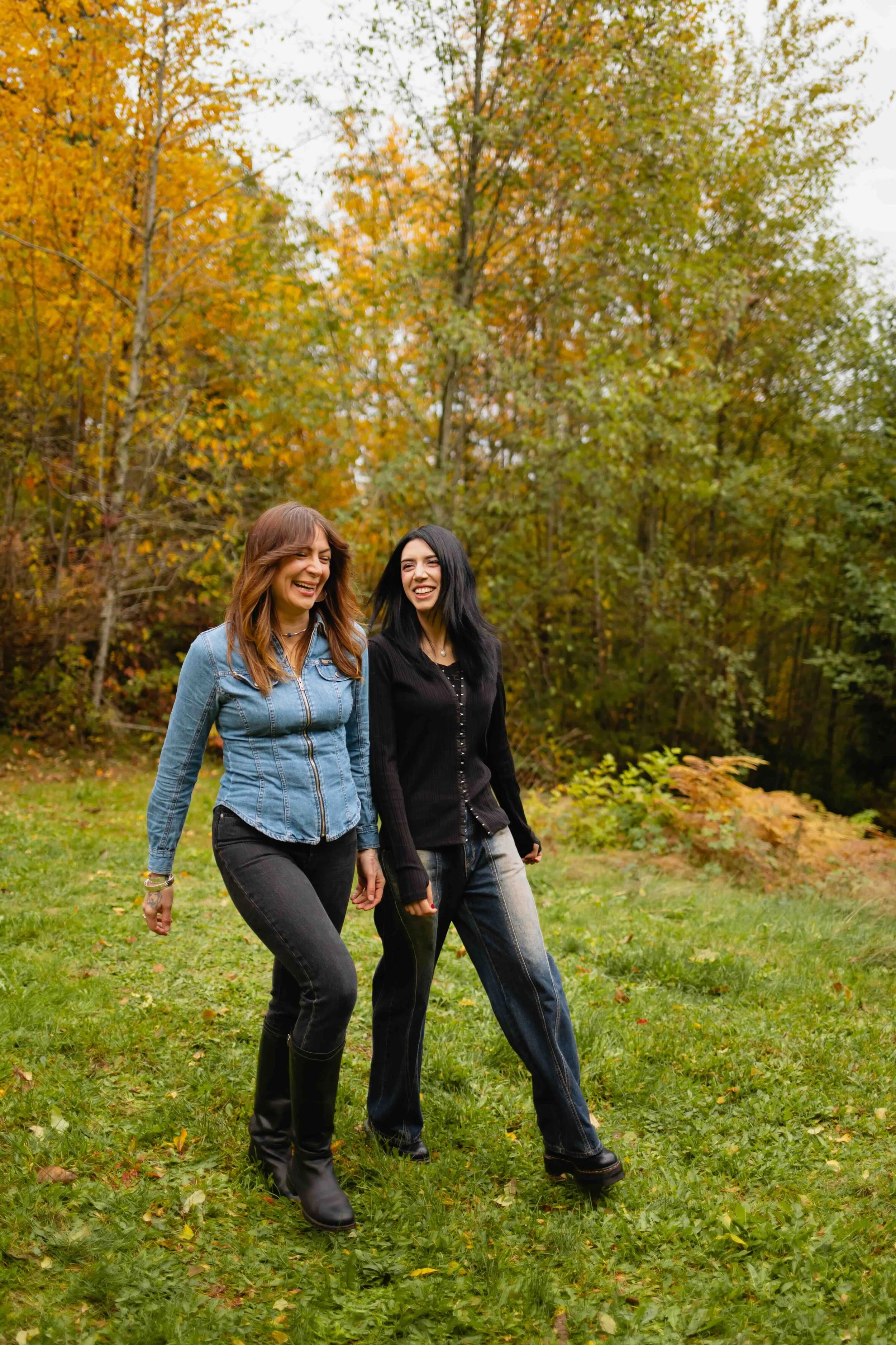Vancouver mother and adult daughter walk and laugh with fall background