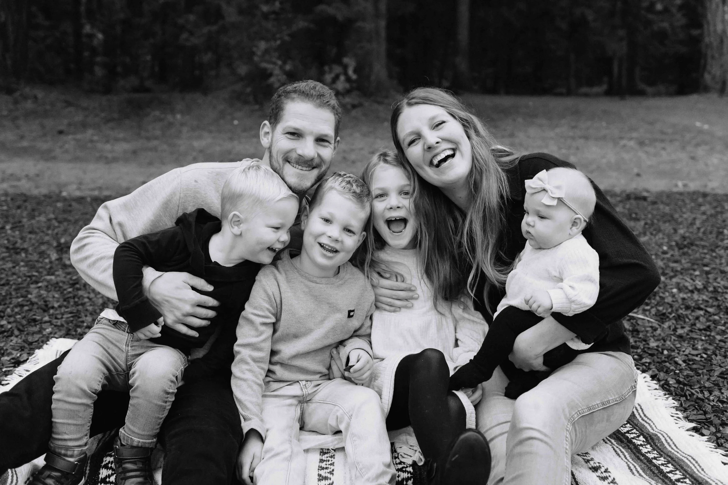 Young Vancouver family hugging and smiling in casual clothes