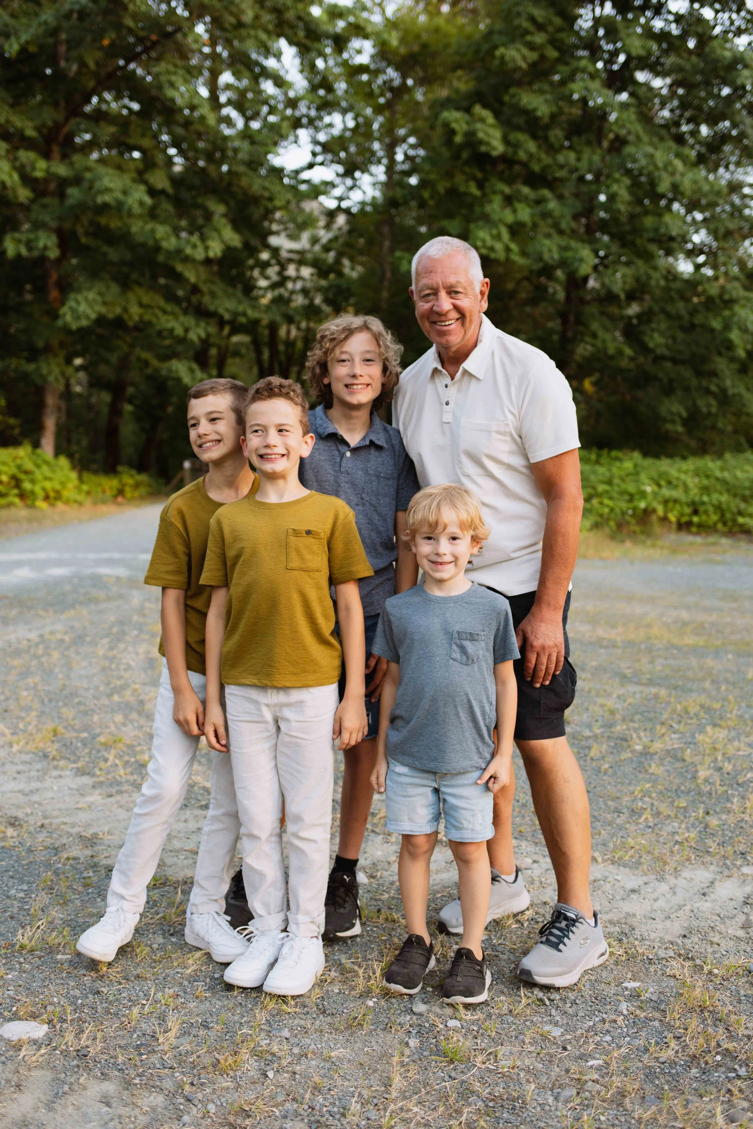 Vancouver Grandpa smiles with grandkids in Fraser Valley forest