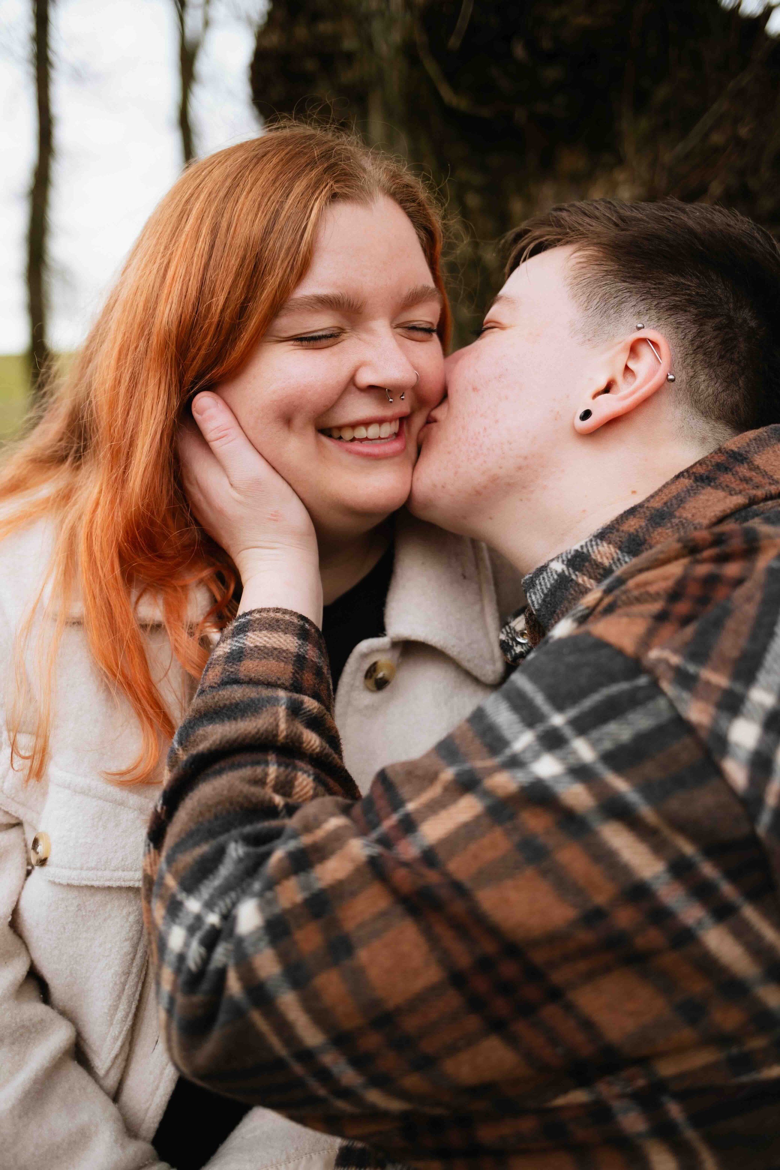 Vancouver woman tenderly gives her girlfriend a kiss on the cheek