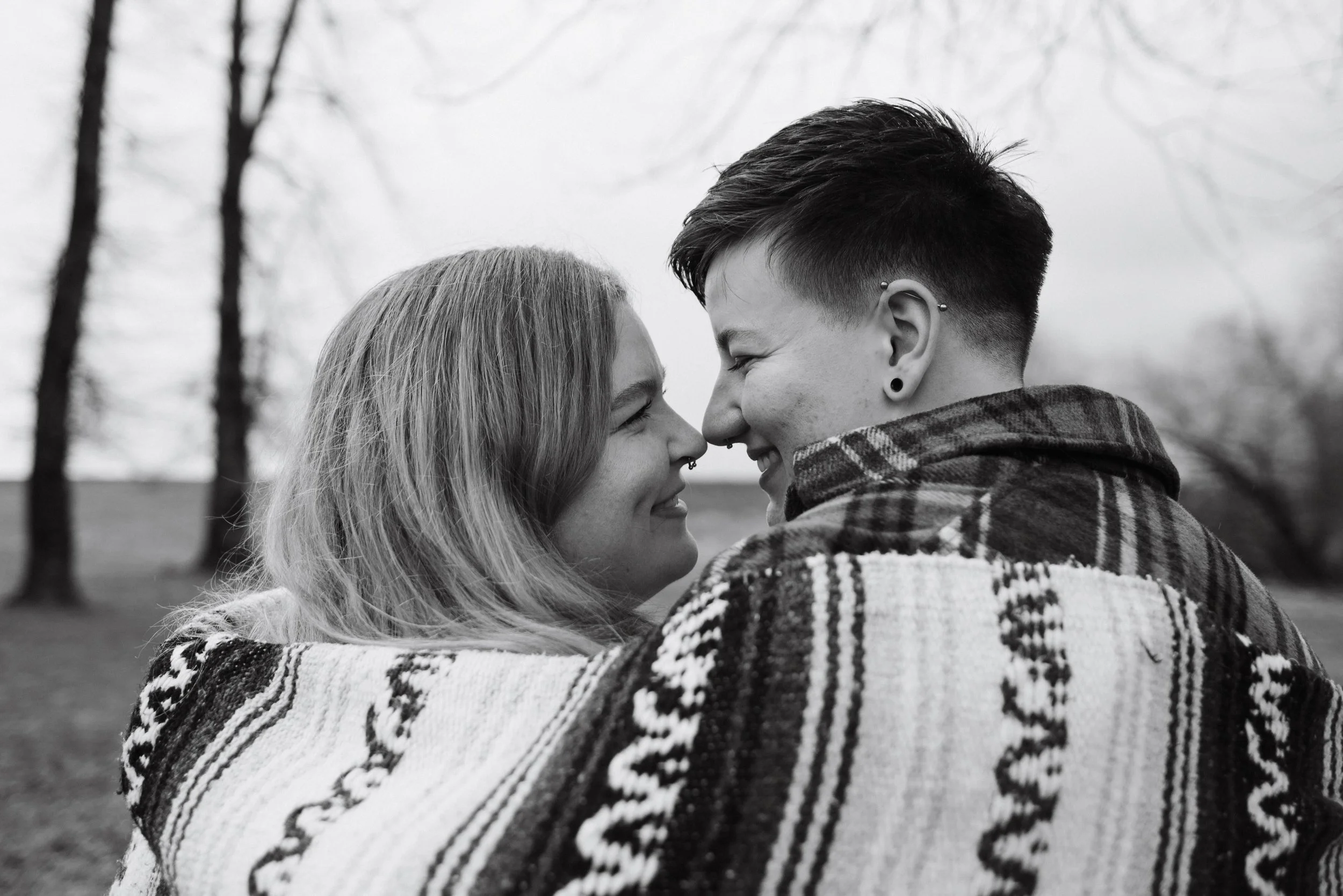 Lesbian Vancouver couple romantically smiling at each other and touching noses