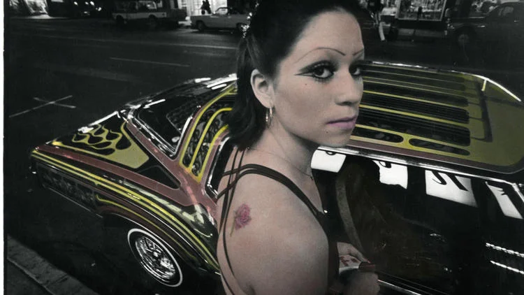 In his later years, Ricardo Valverde took some of the early photographs he had taken and applied pigment to them, giving his work a hallucinatory feel. “Boulevard Night,” from 1979/91, includes one of his favorite subjects: low riders. (Ricardo Valverde / VPAM)