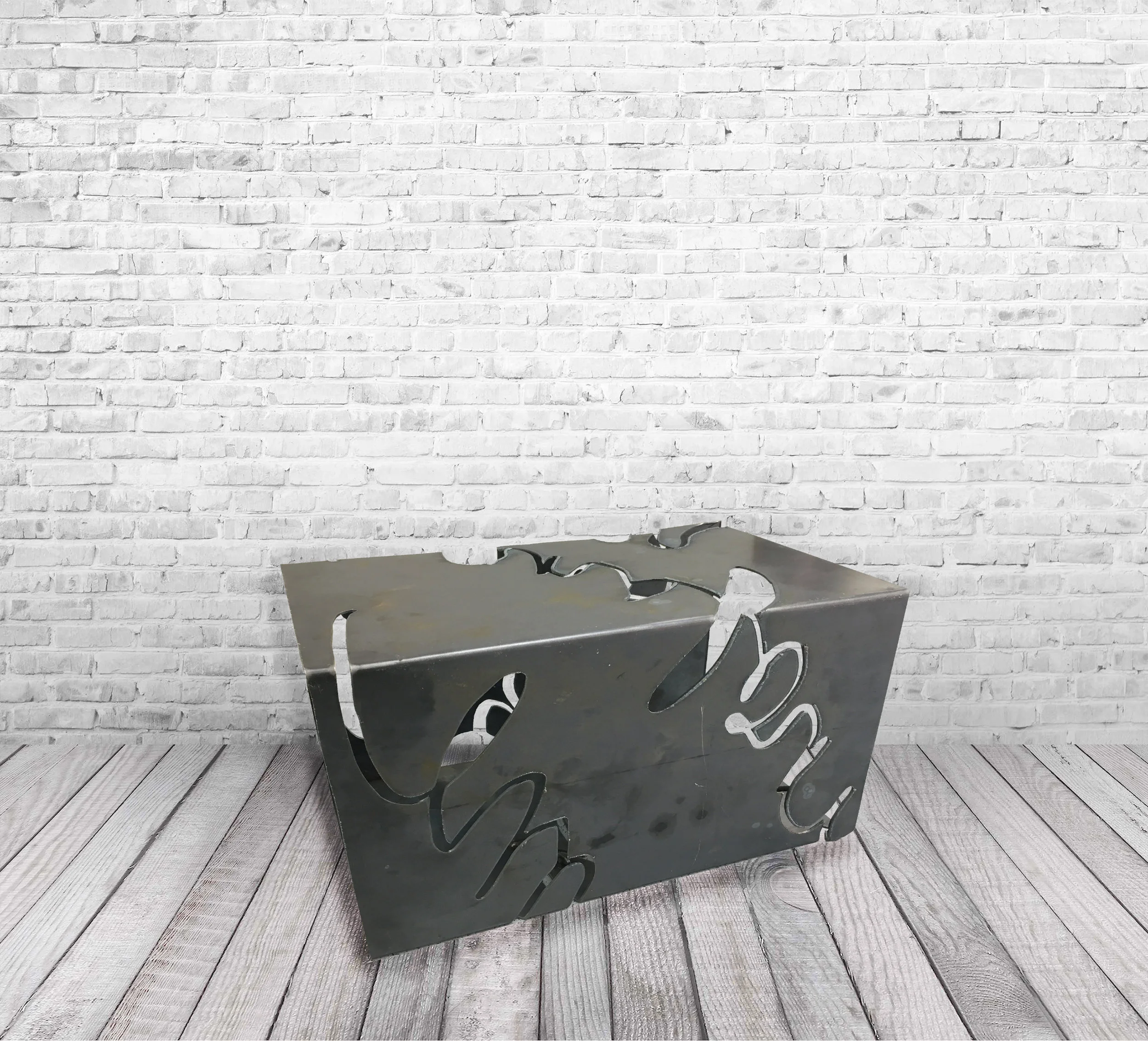 NEGATIVES // FURNITURE Plasma cut steel table bent from a continuous slab of metal. A series of words were removed, allowing the user to "see through steel". 