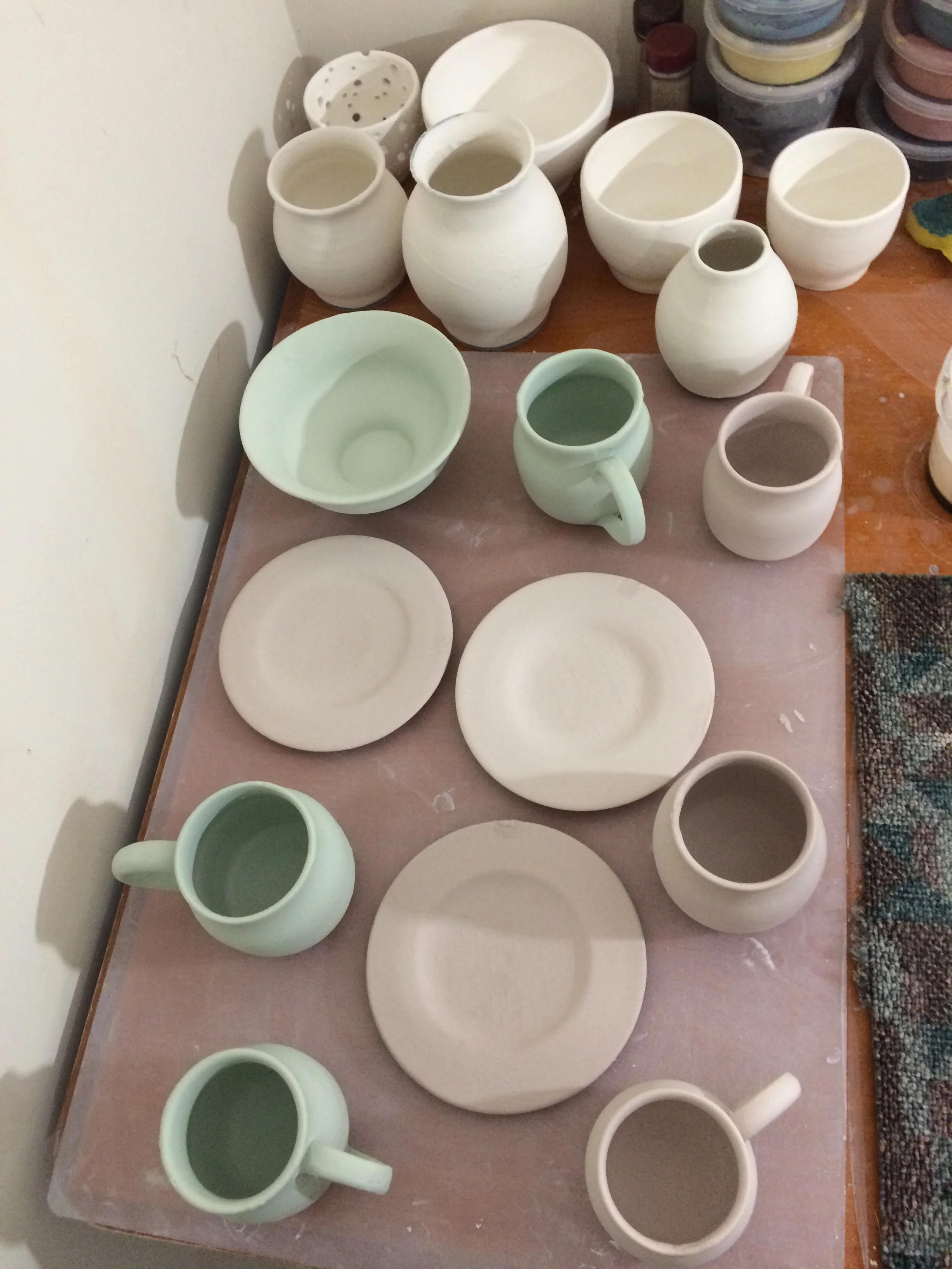 The glaze sets on the pots in certain colours but this does not indicate what colour they will be when they are fired!