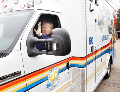 Pat Ryan, in the front seat of the commemorative ambulance that features photos of him and his brother, Paul Ryan, who started the business in 1962.