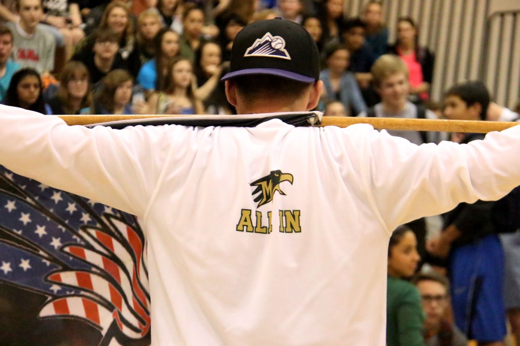Junior Coby Petau watches on as the gym shifts over to make way for the class of 2019. Petau received the flag draped over his shoulders from the graduating senior class to continue the legacy they laid out. 