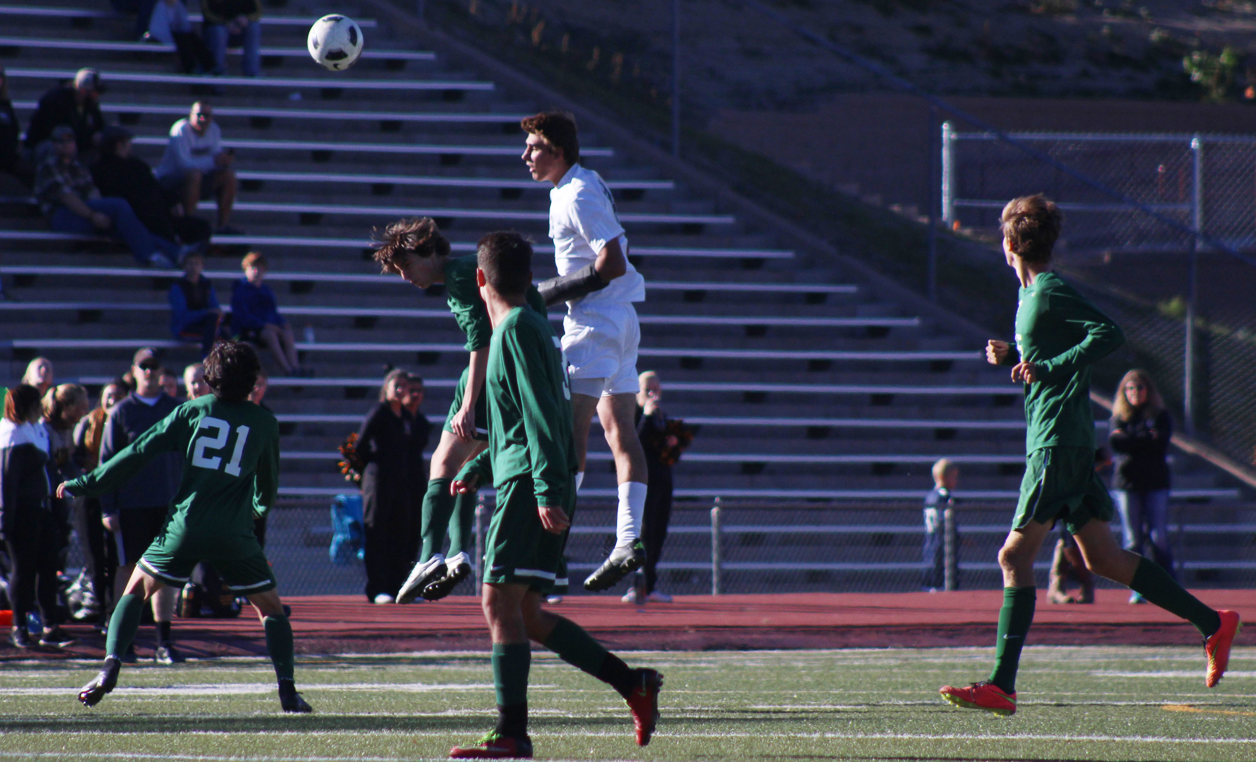 Senior Matias Grossi and an Arapahoe player head a ball into Vista territory. 