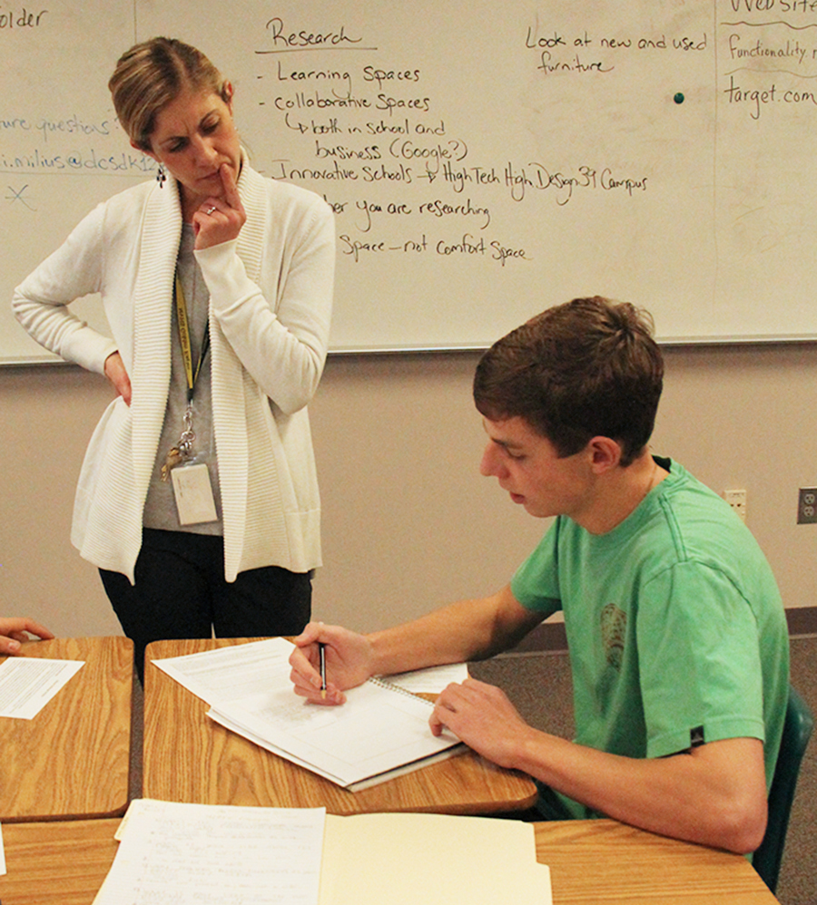 English teacher Kelly Paulson watches over as sophomore Benny Cope works on a redesign project. Students were redesigning their classrooms to create better learning environments.