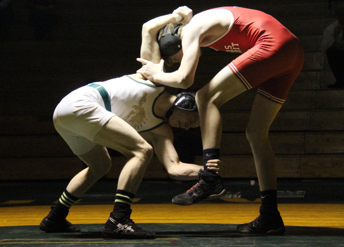 Junior Justin Schroeder competes in a wrestling match against Heritage High School.