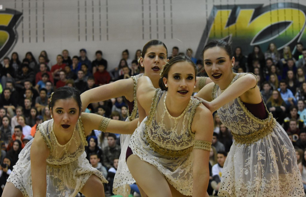 Freshman Makenna Hollingshead and three other varsity poms dancers perform during the state championship assembly. Hollingshead is one of three freshman on the varsity team.