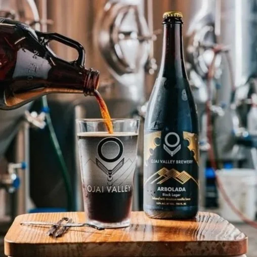 Black Lager pouring into pint glass in brewery