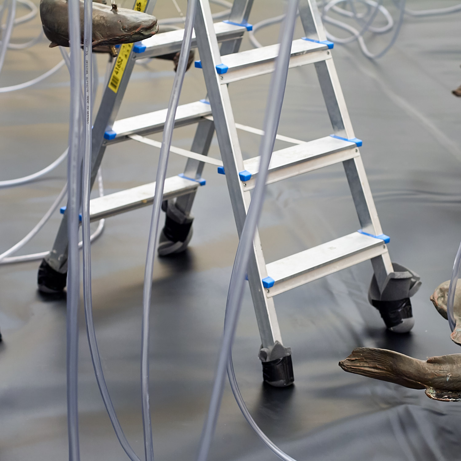Step ladder with clear plastic tubing