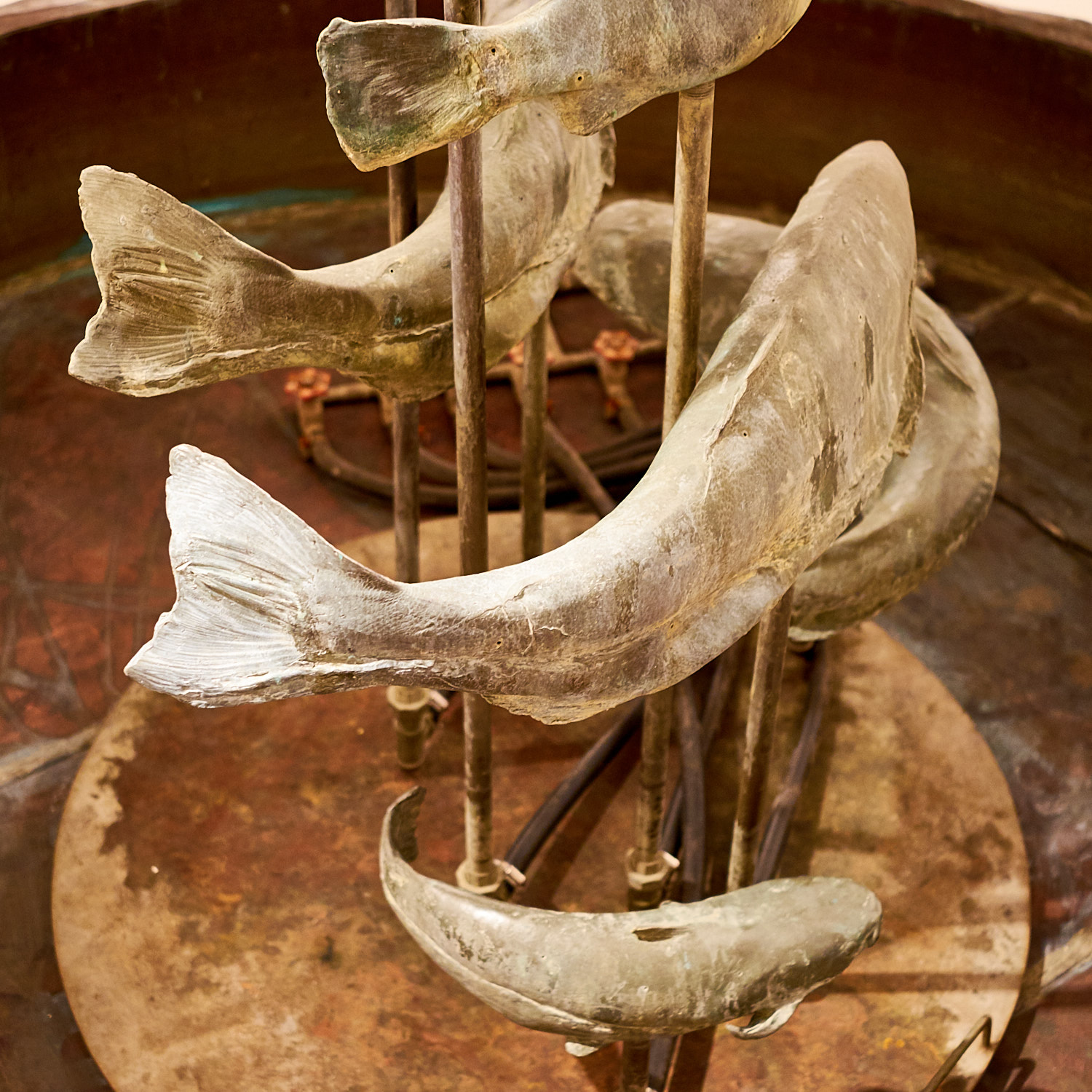Sculpture of fish swimming on metal rods