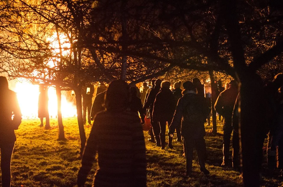 Everyone from the village around the bonfire in the orchard.