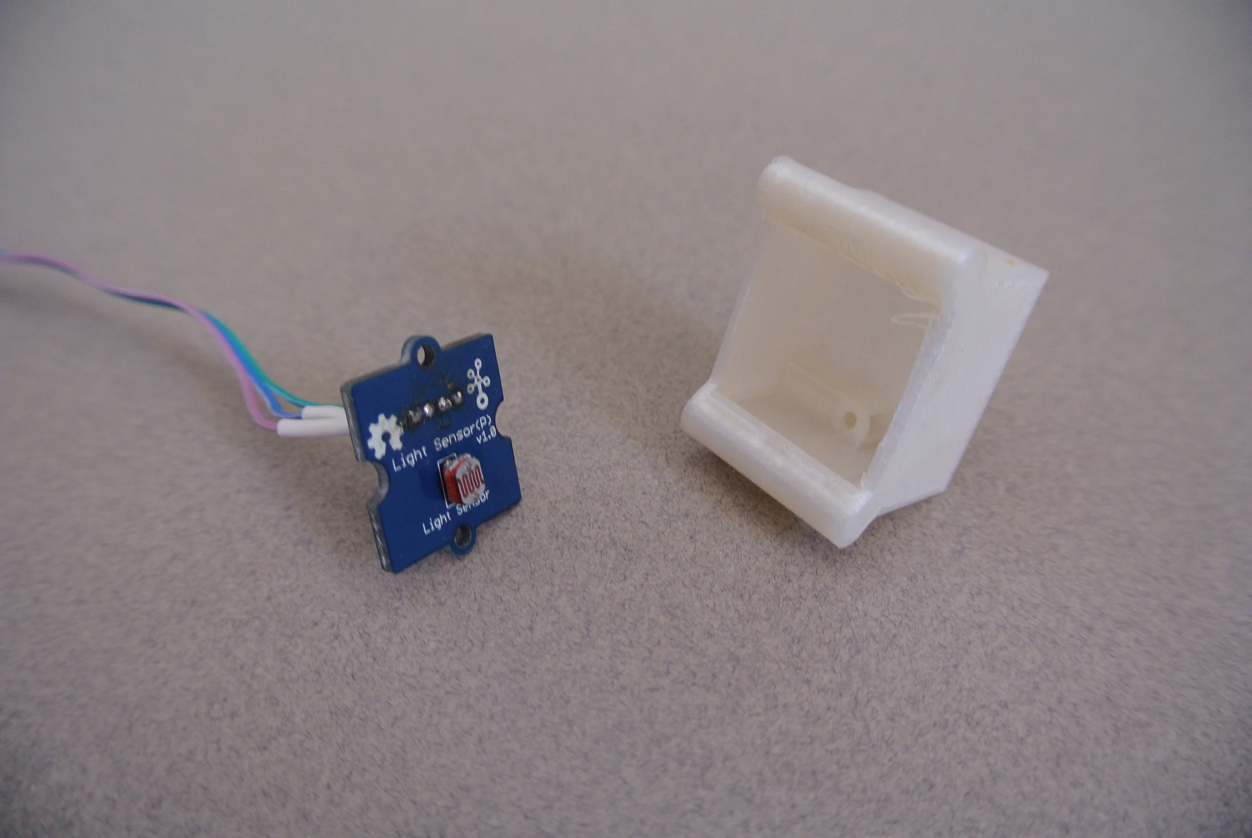 One of the four Grove light sensors and its enclosure that slide into the legs of the seat.