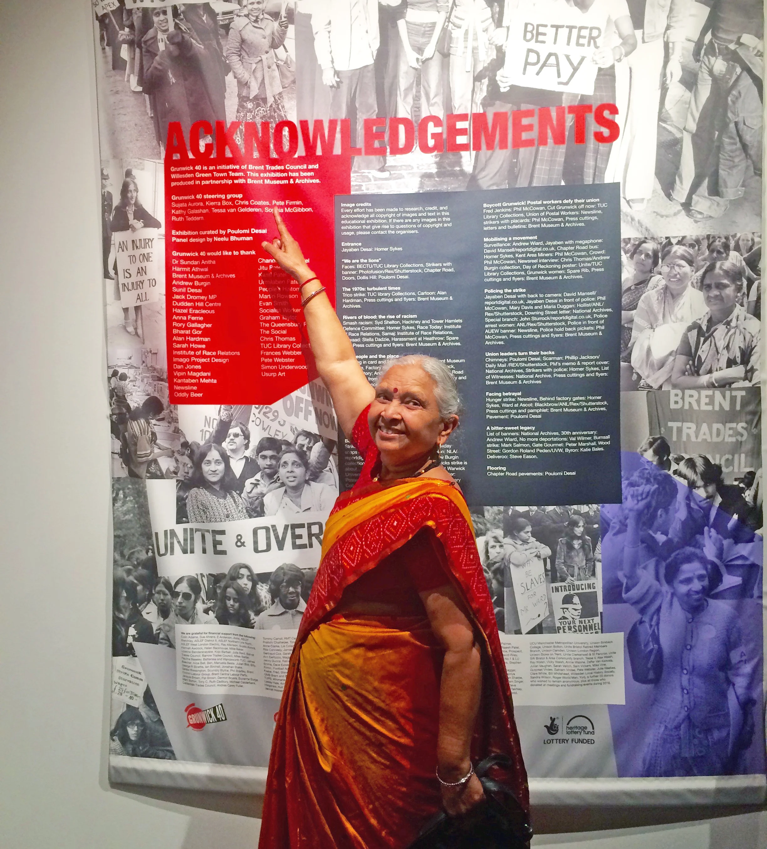 A grunwick striker pointing to an image of herself from the strike.