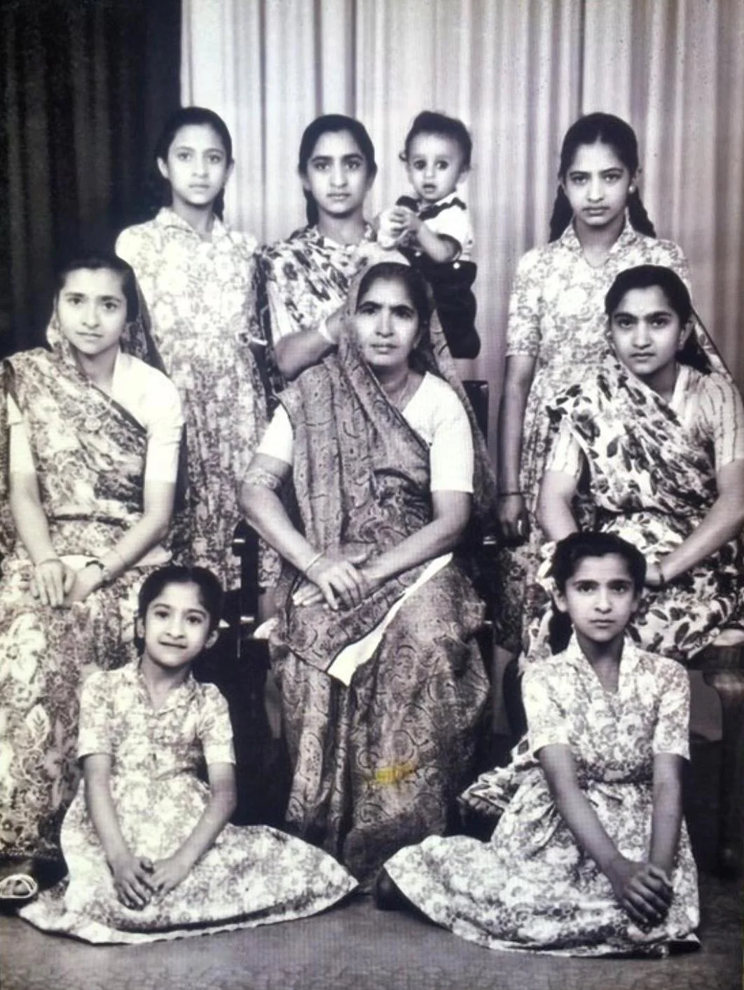 A family photo with a young Champa holding her son in the back row. Credit: Jodie Ravina Champaneria