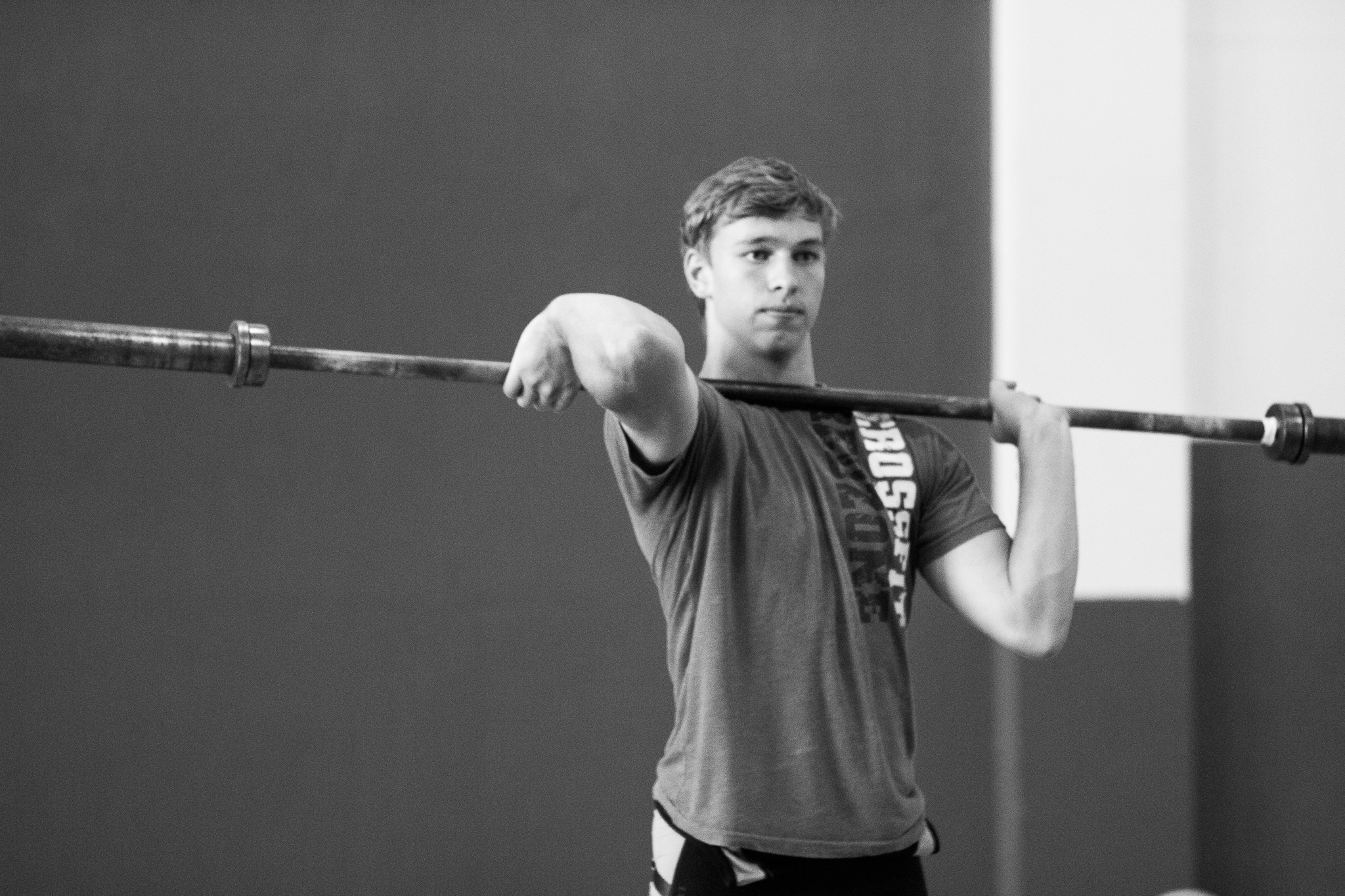 youth-weightlifter-stretching-barbell.jpg