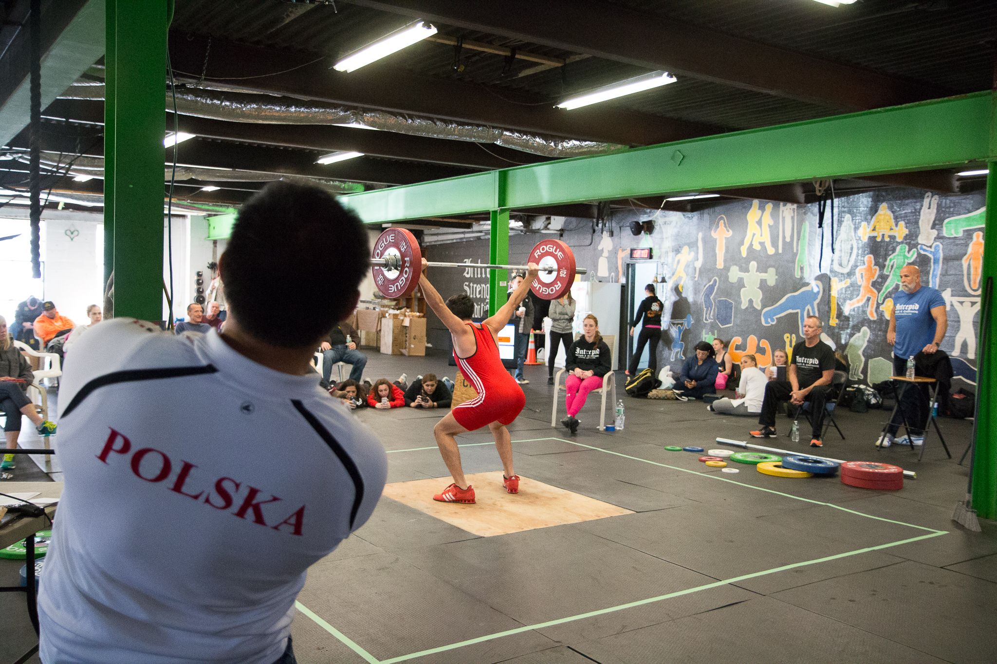 "The Coach Lean Back Posture" by coach Joel Quintong from Sacred Heart University Weightlifting . He is doing more than just looking at his lifter. He is checking his form and giving cues. 