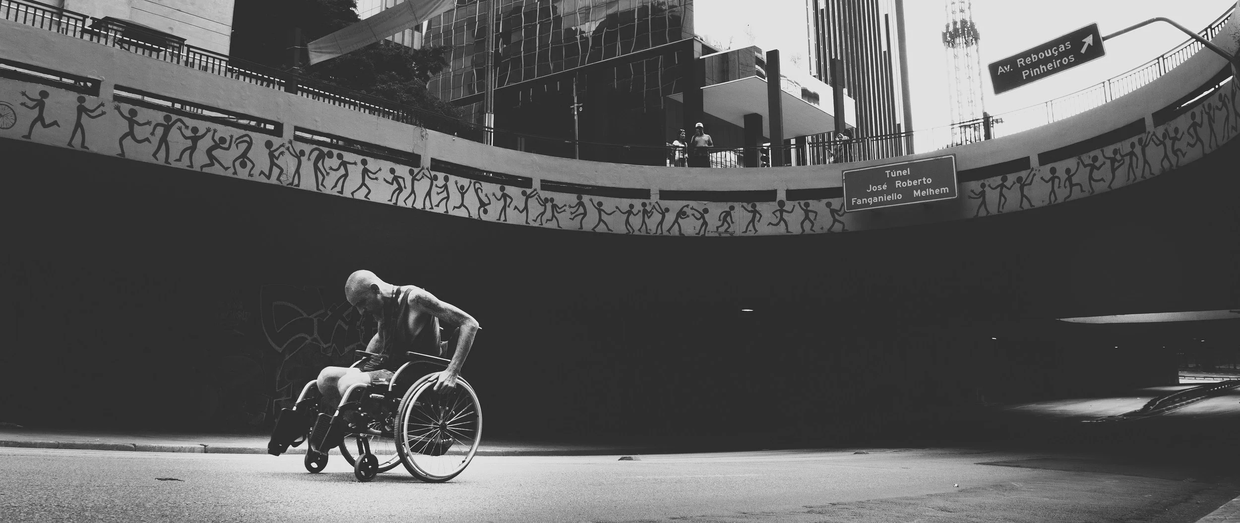 Disabled man wheelchair alone on street.jpg