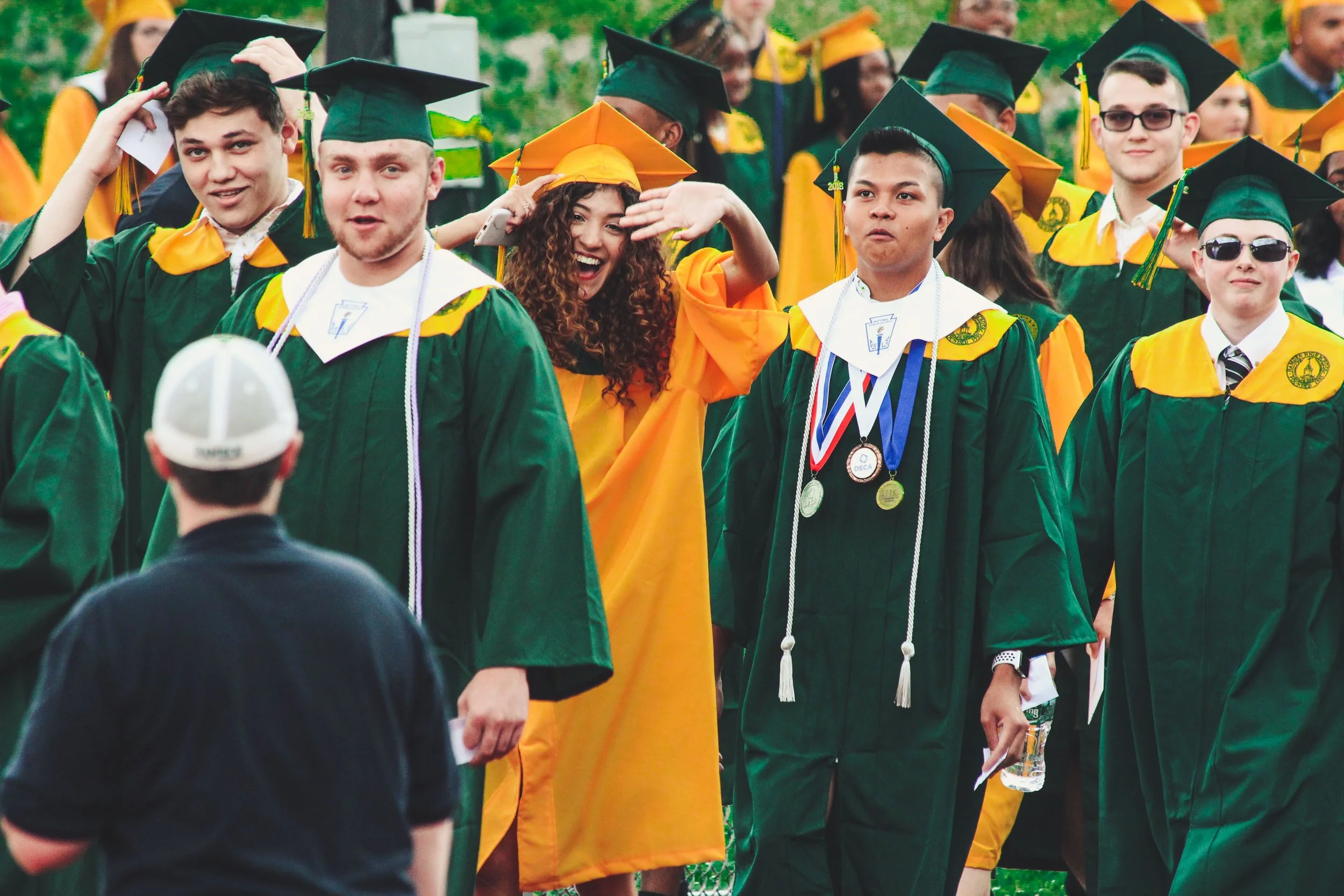 Graduation students walking in cap gown.jpg