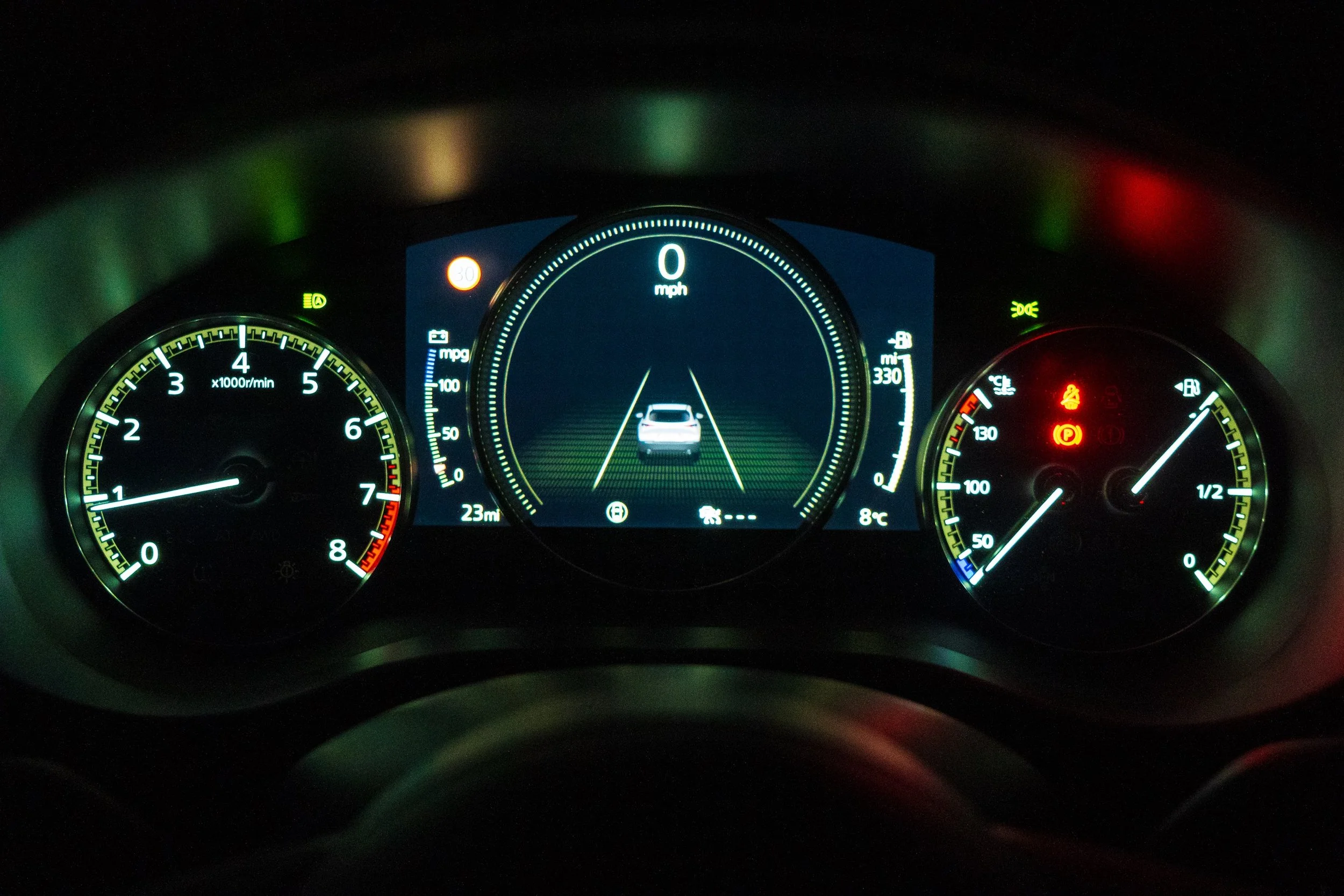Car dashboard with warning lights illuminated.