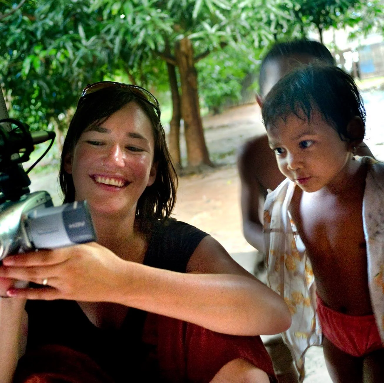 Cambodia, 2008 - Jessica Chance shows Yai and Yong pictures of themselves while reporting on multiple drug resistant TB at an HIV treatment center run by Buddhist monks in Siem Reap. MDR TB is an increasing threat to people living with HIV in SE Asia.