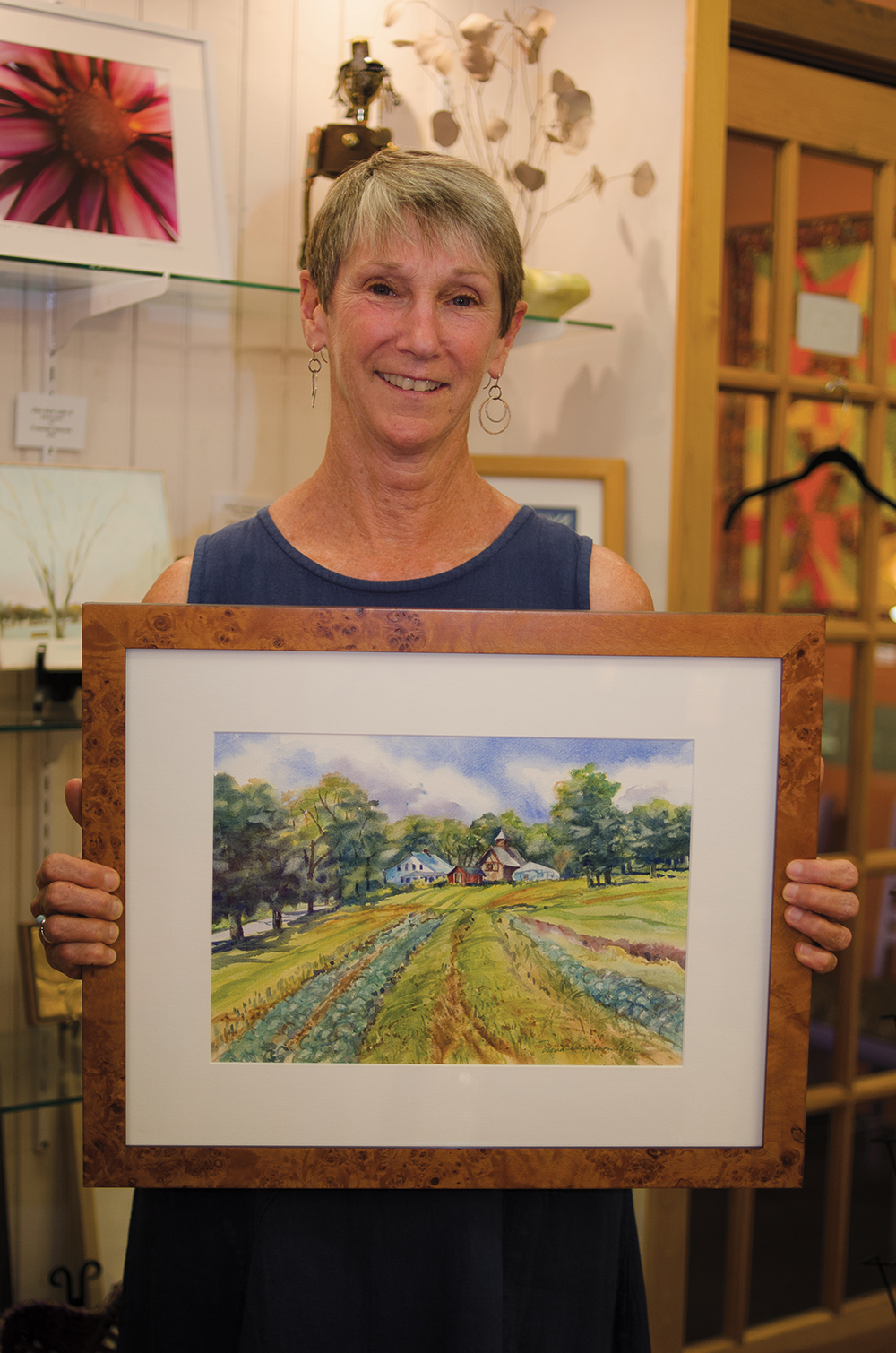  Painter Nina Anderson Coler displays one of her landscapes