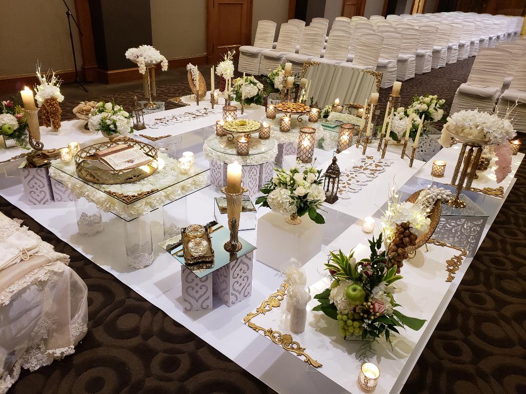 Antique Gold sofreh set up on white vinyl platform. One King West Hotel Toronto