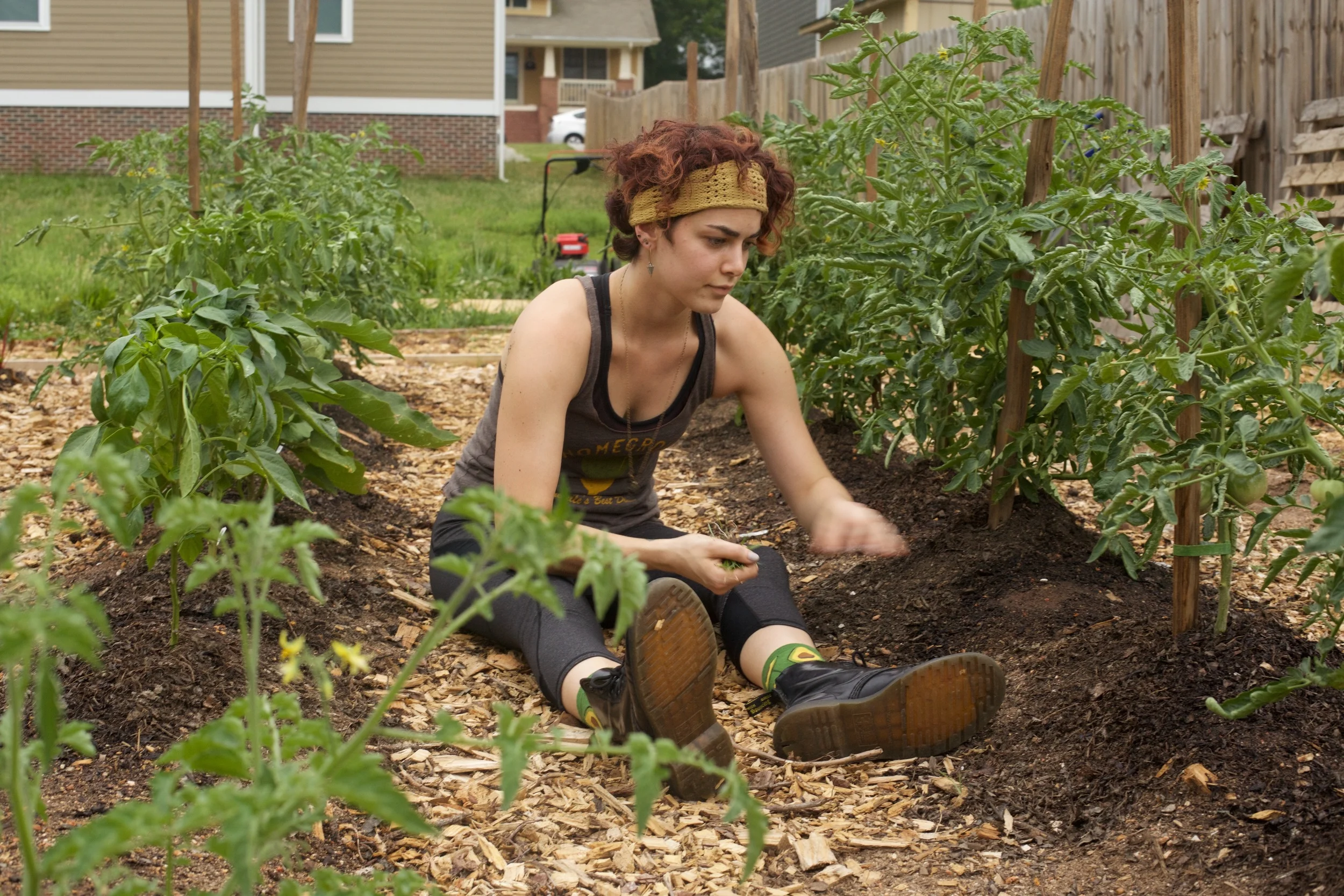 Andie inspects the tomato plants (avocado socks...nice)