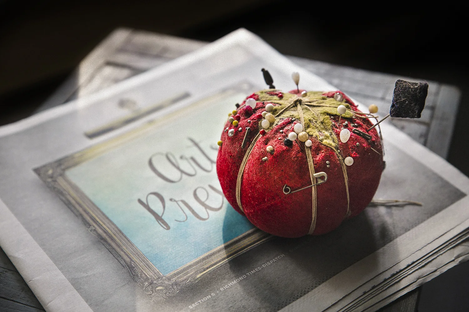 the pincushion on the Sunday paper, Artist Preview section