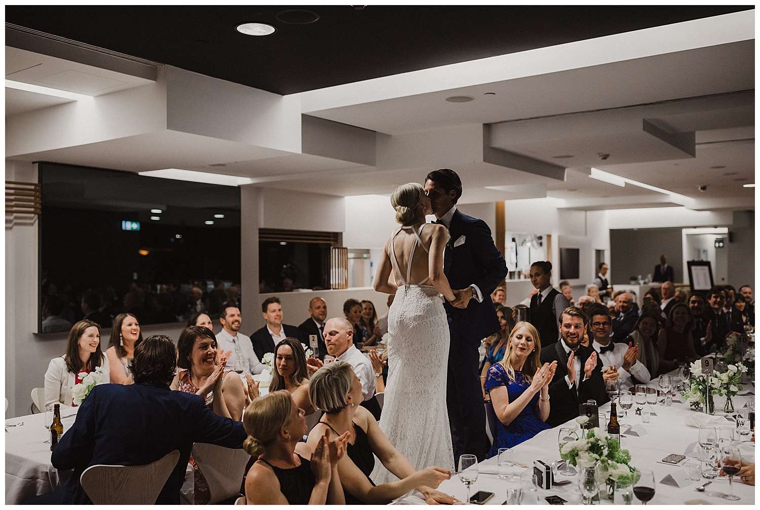 Bride and Groom kiss during a Swedish wedding tradition at their MCA Wedding Reception.