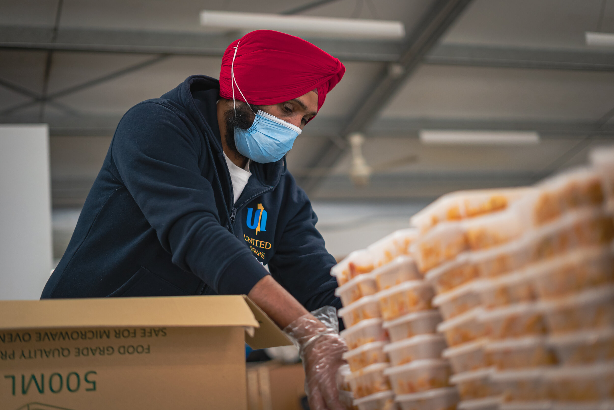 UNITED SIKHS packing meals for local communities.