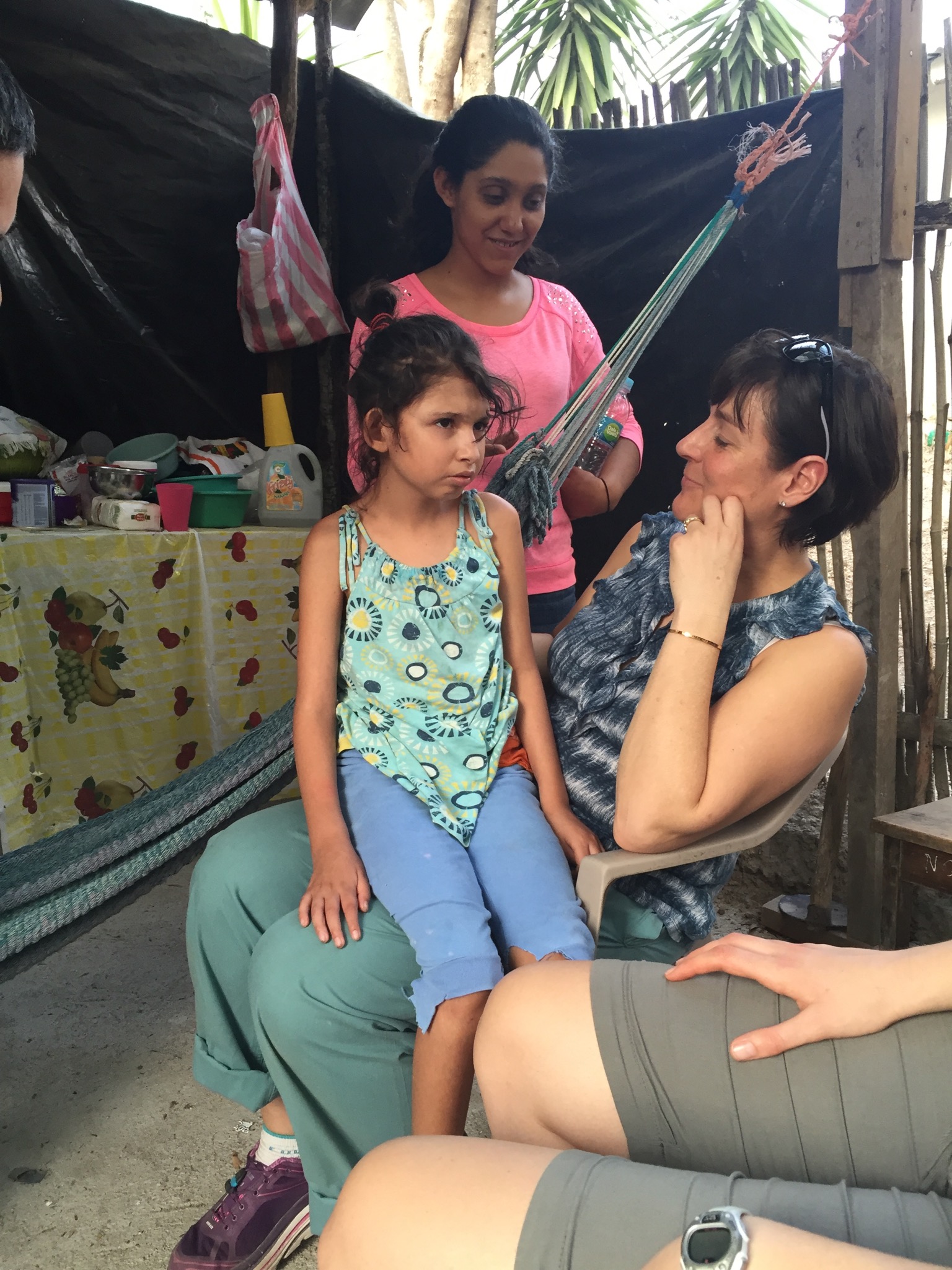 Johanna sitting with Ashley in her home. One of our translators, Kim, is in the background of the photo. 