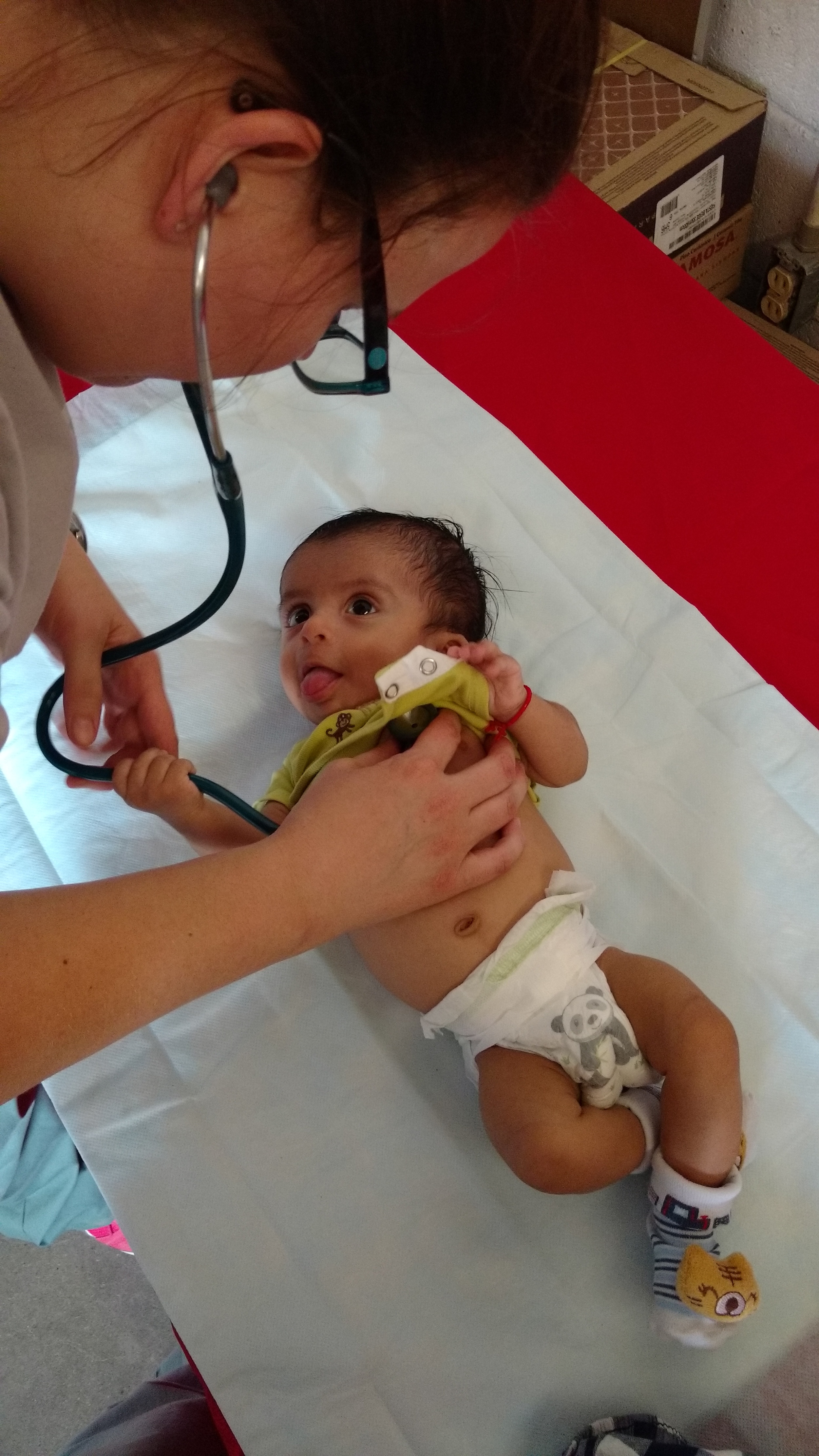 Dr. Heather Flieger assessing this adorable infant with congenital heart disease.