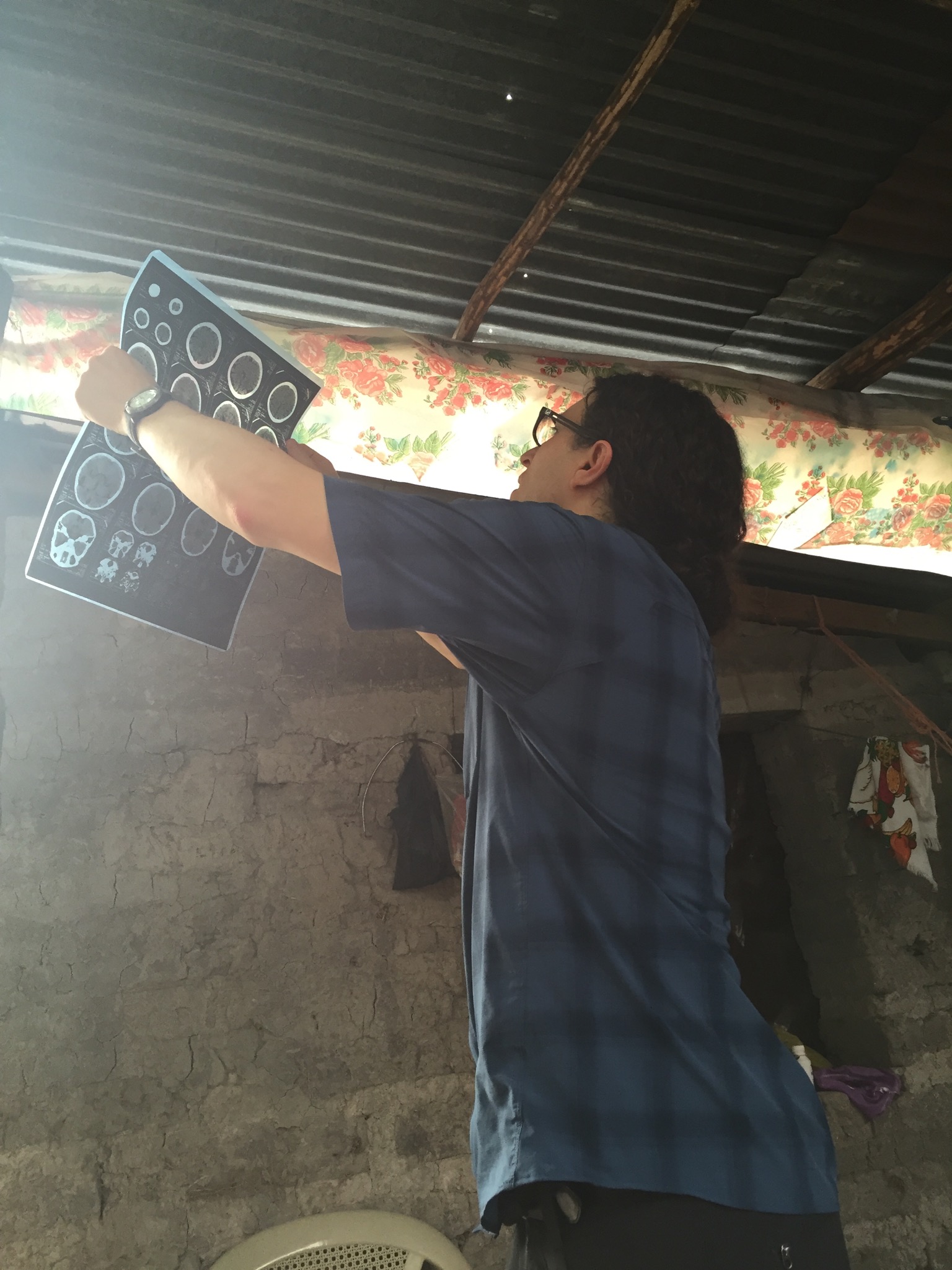 Dr. Klein examines a patient's CT images at a home visit.