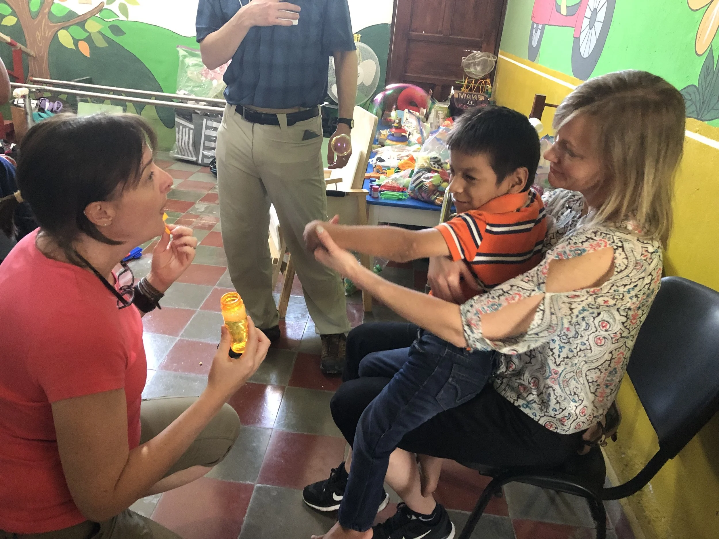 Laura and Bernette working with a new friend and checking his mobility.