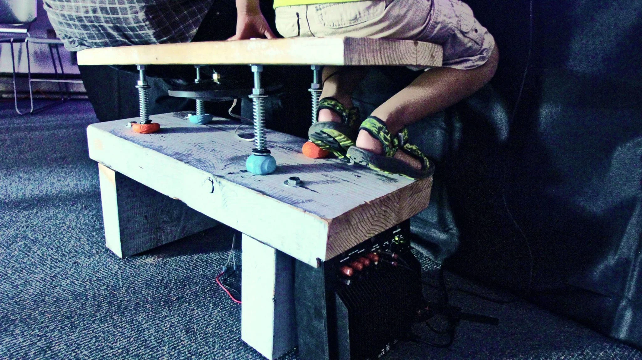 Audience members experience a CymaSpace show through this specially made bench through which music is a tactile experience.