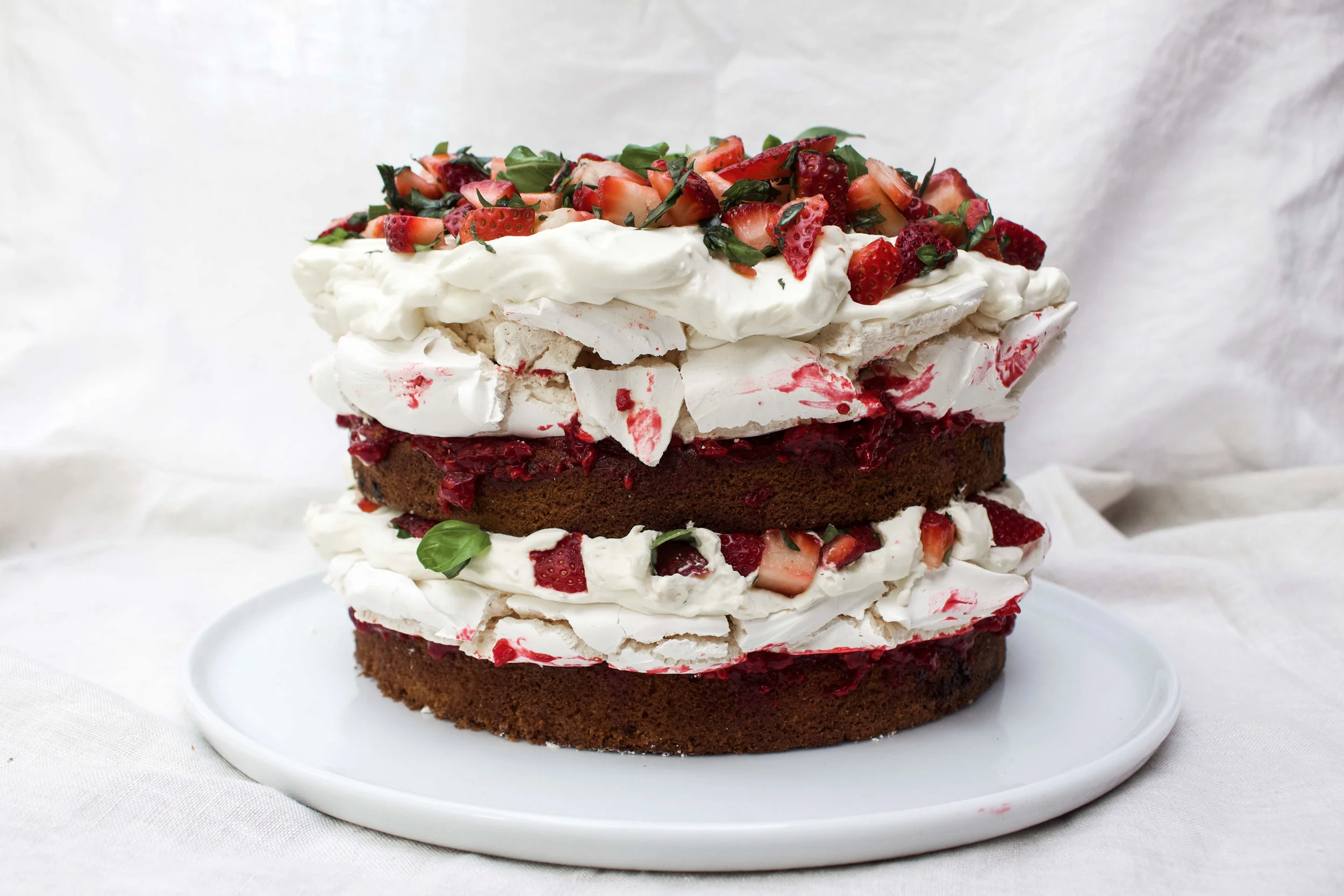 < victoria sponge w/ meringue layers, cream, strawberries &amp; basil >
