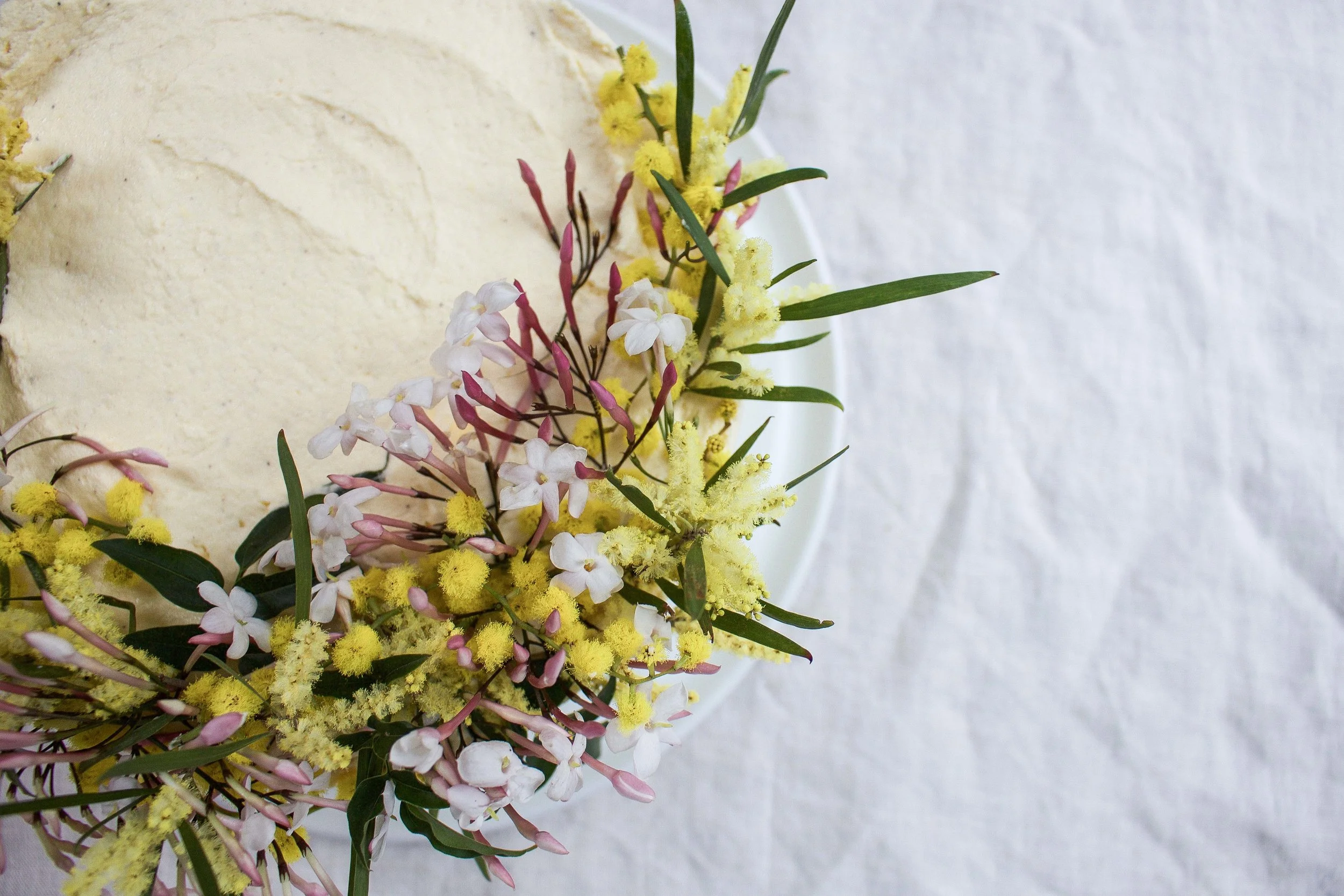 malted wattle seed cake with honey cream cheese icing &amp; salted white chocolate crumbs